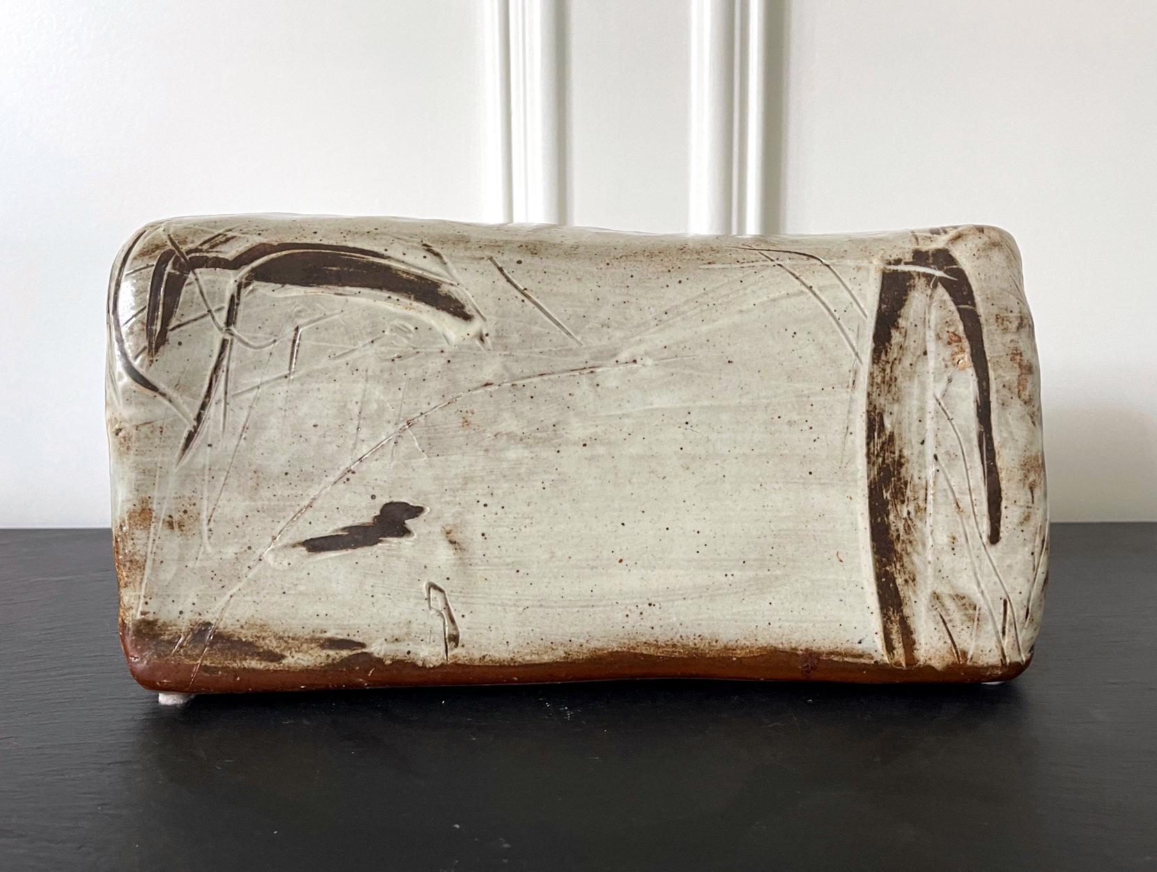A ceramic sculpture piece created in the tradition of Buncheong ware by contemporary Korean ceramicist Sung Jae Choi (South Korean, b. 1962). In a hollow rectangular with slight irregularity of being hand-made, the piece evokes the distant memory of