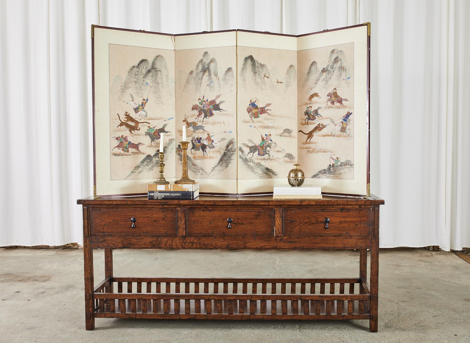 Magnificent Korean Showa period four-panel screen depicting hunting scenes with tartars in a mountain landscape. The screen is decorated with vibrant ink and natural color pigments on hand-crafted paper. Probably from the period of the Japanese