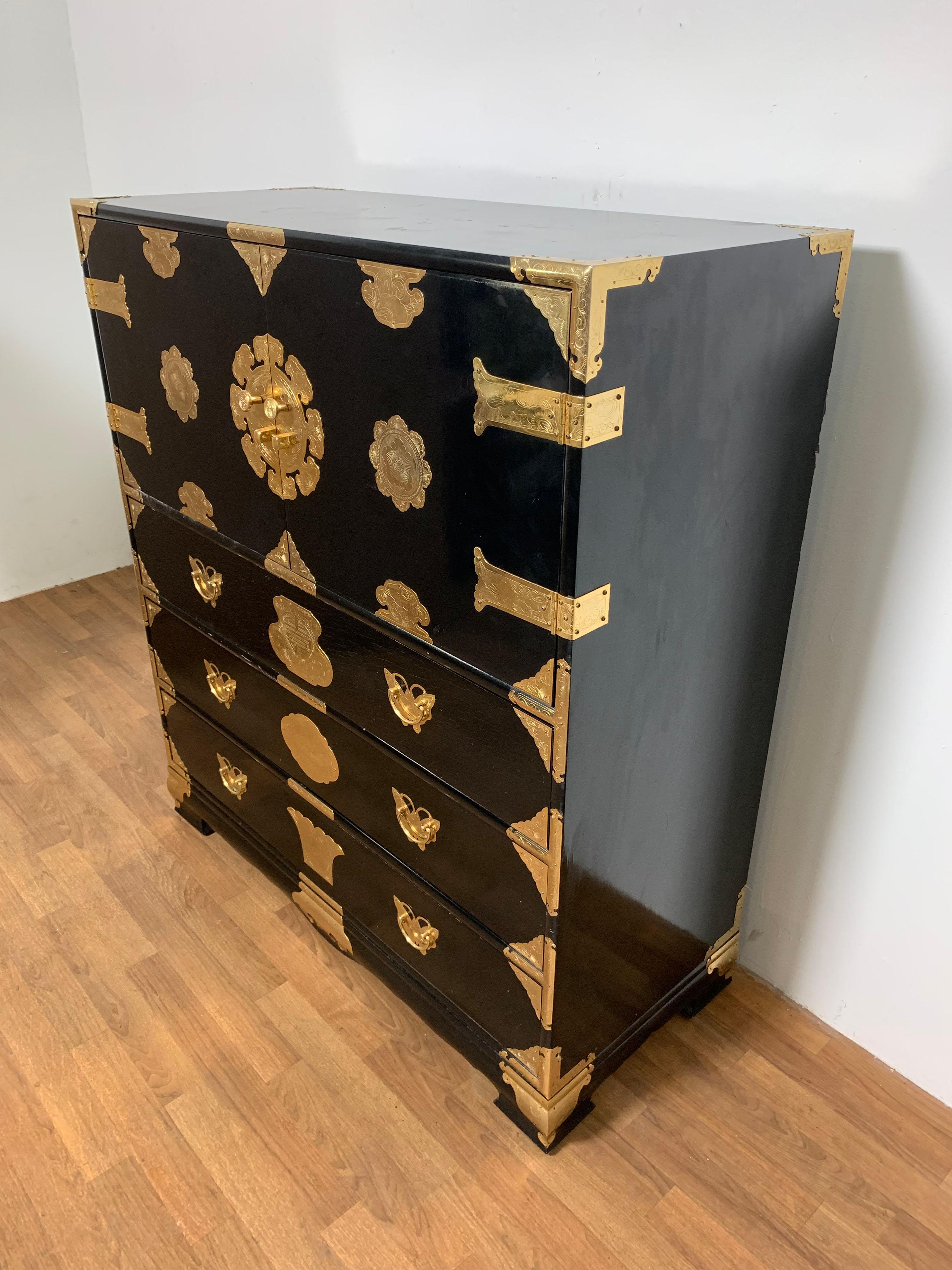 Generously proportioned mid-century chest in black lacquer with brass strapwork, in the manner of a Korean bandaji (blanket chest).