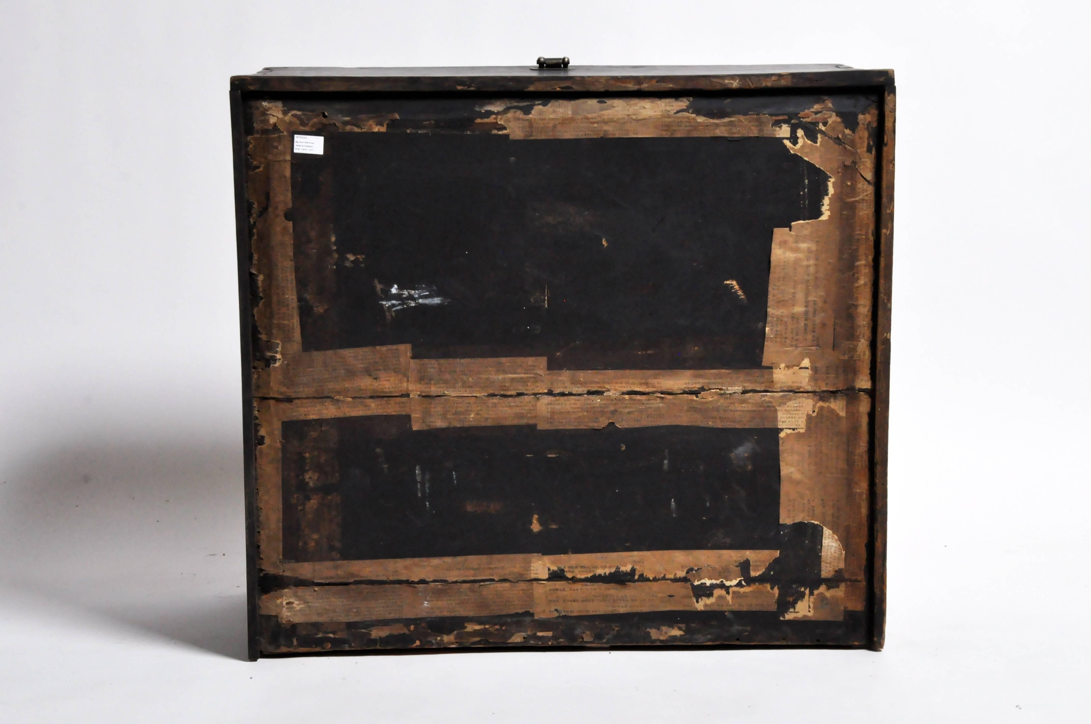This softwood storage trunk has highly stylized decorative iron fittings, and was used to hold blankets, garments and other gifts that would be presented to the newlyweds as part of the dowry. It has a fall-front opening and large metal handles for