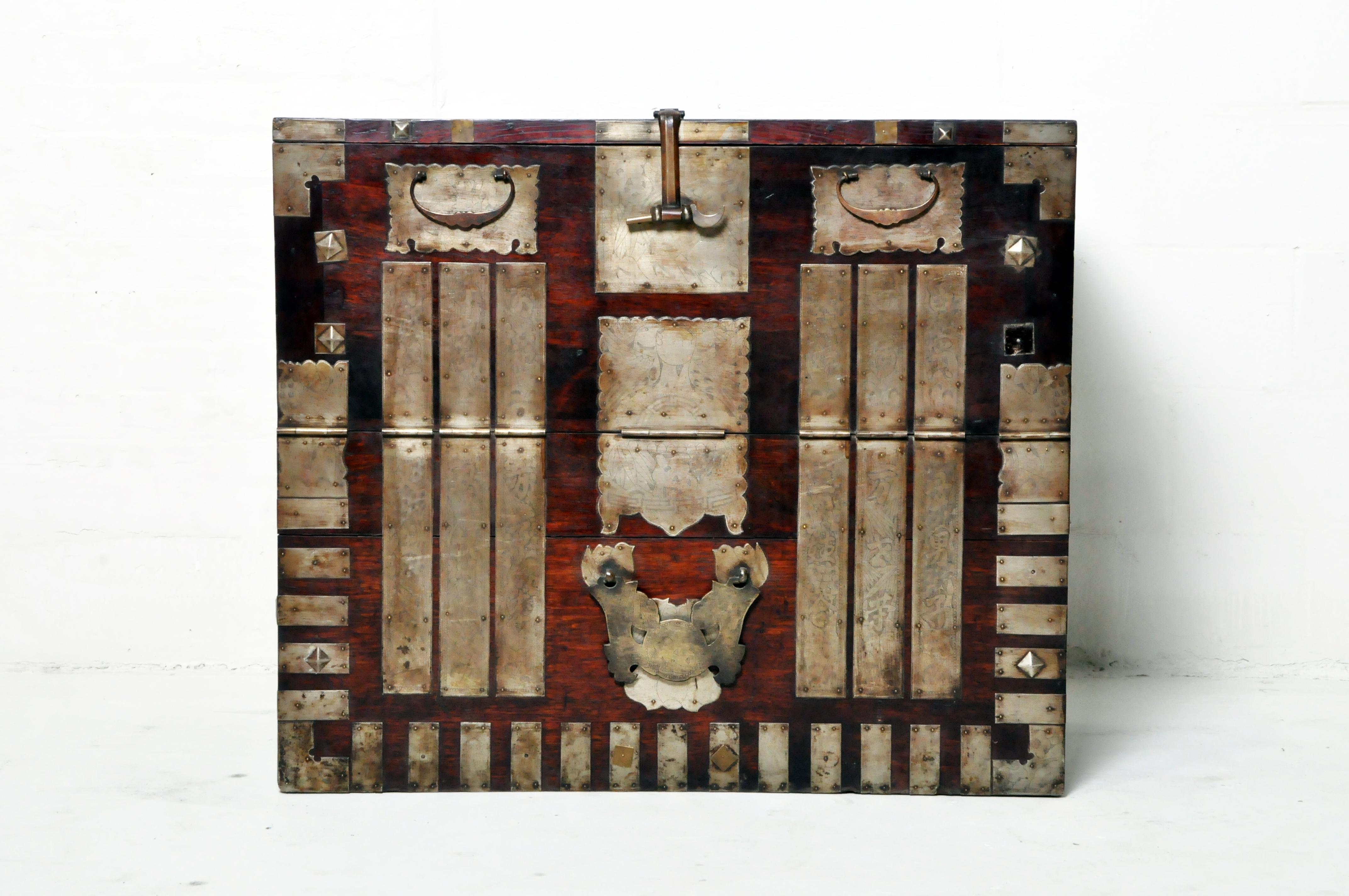 This simple Korean chest once contained blankets and clothing items given as part of a marriage dowry. The elaborate hardware is made from a tin alloy and has been engraved with auspicious patterns. The interior of the chest has been cleaned and