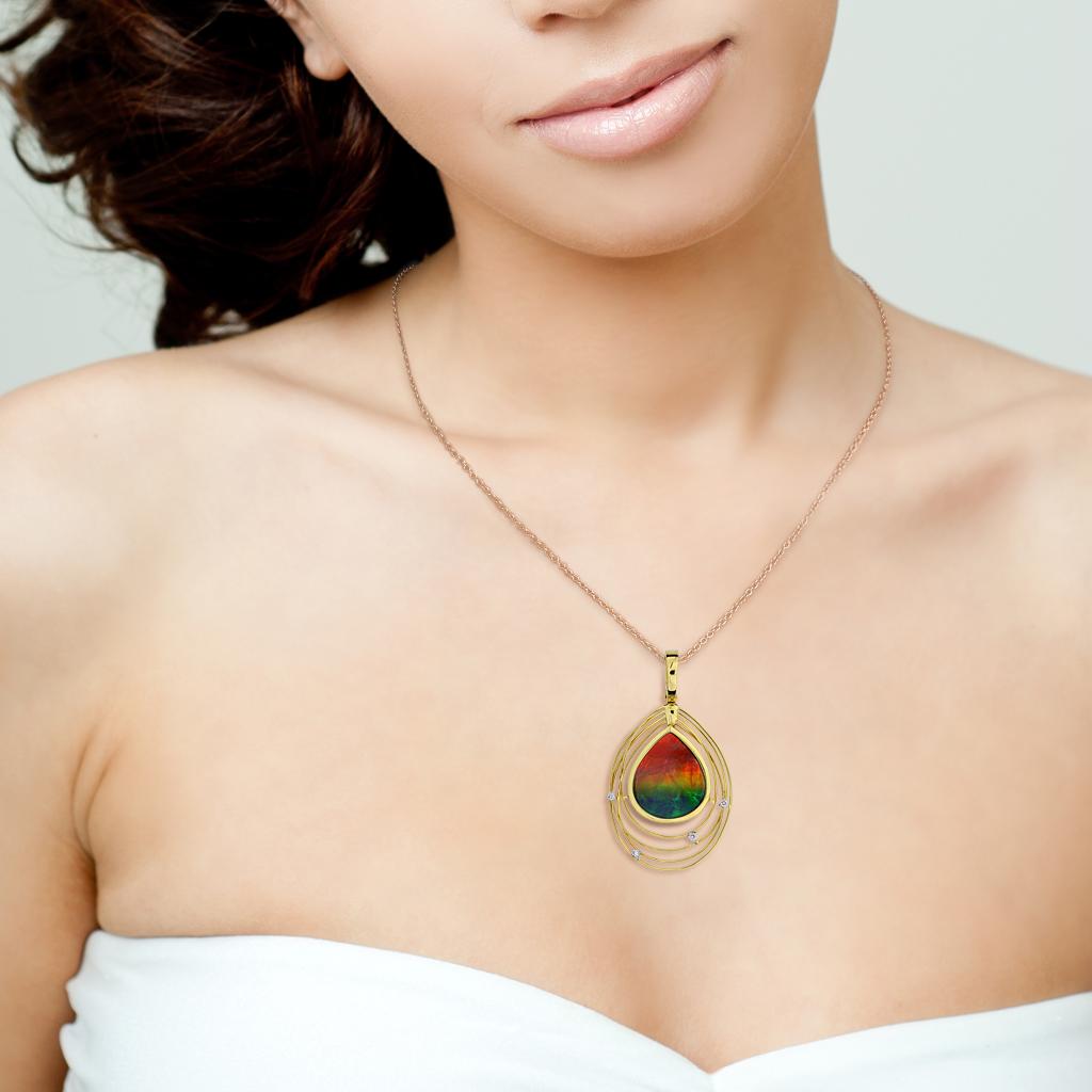 Designed by Korite this Solara ammolite pendant is a classic with stone of naturally captivating colors and layers of brilliant iridescence. This prehistoric gem is pear cut set in 18k yellow gold with diamond highlights.

Hallmarks: 18K, Ammonite