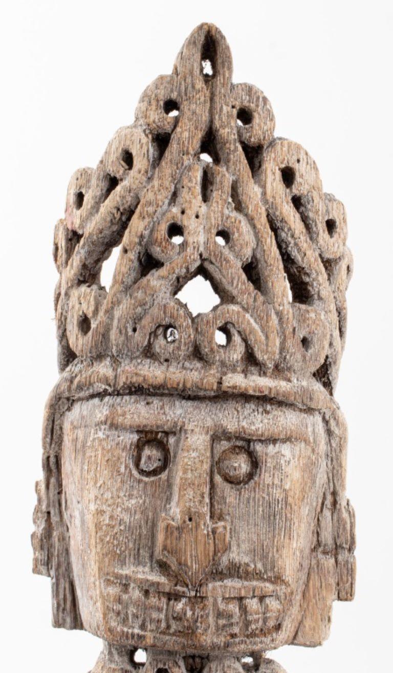  Korwar Carved Wood Ancestor Sculpture, Indonesian, Melanesian, or Papua New Guinea, depiction of ancestor propping his chin on a shield, wearing a crown, single carved piece of wood affixed to black metal base. 

Dealer: S138XX