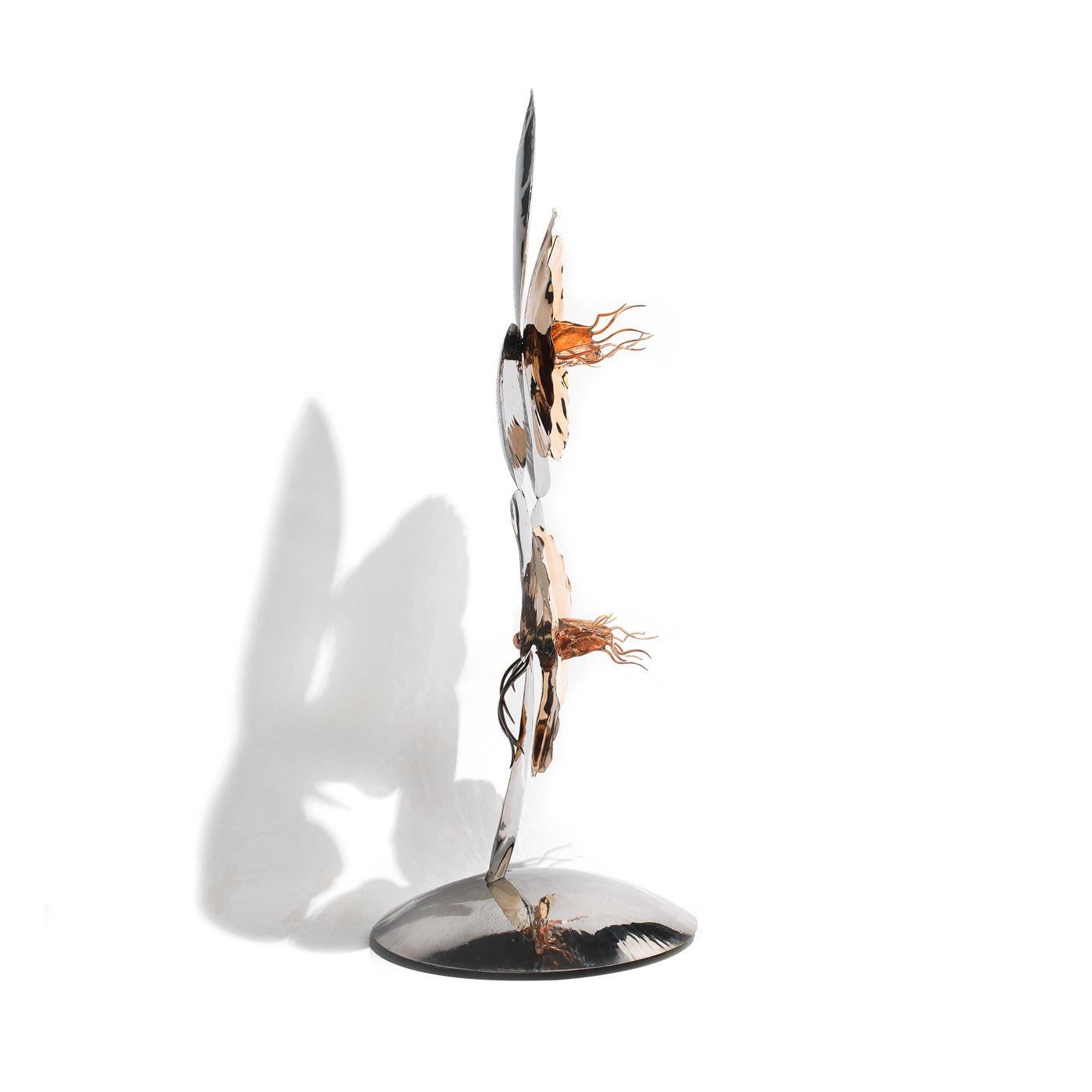 This magnificent sculpture derives its name from the ancient Greek word for orchid: sandal of the world. This work of art is crafted entirely by hand and is made of stainless steel, bronze, and copper to create a multicolored effect. The refined