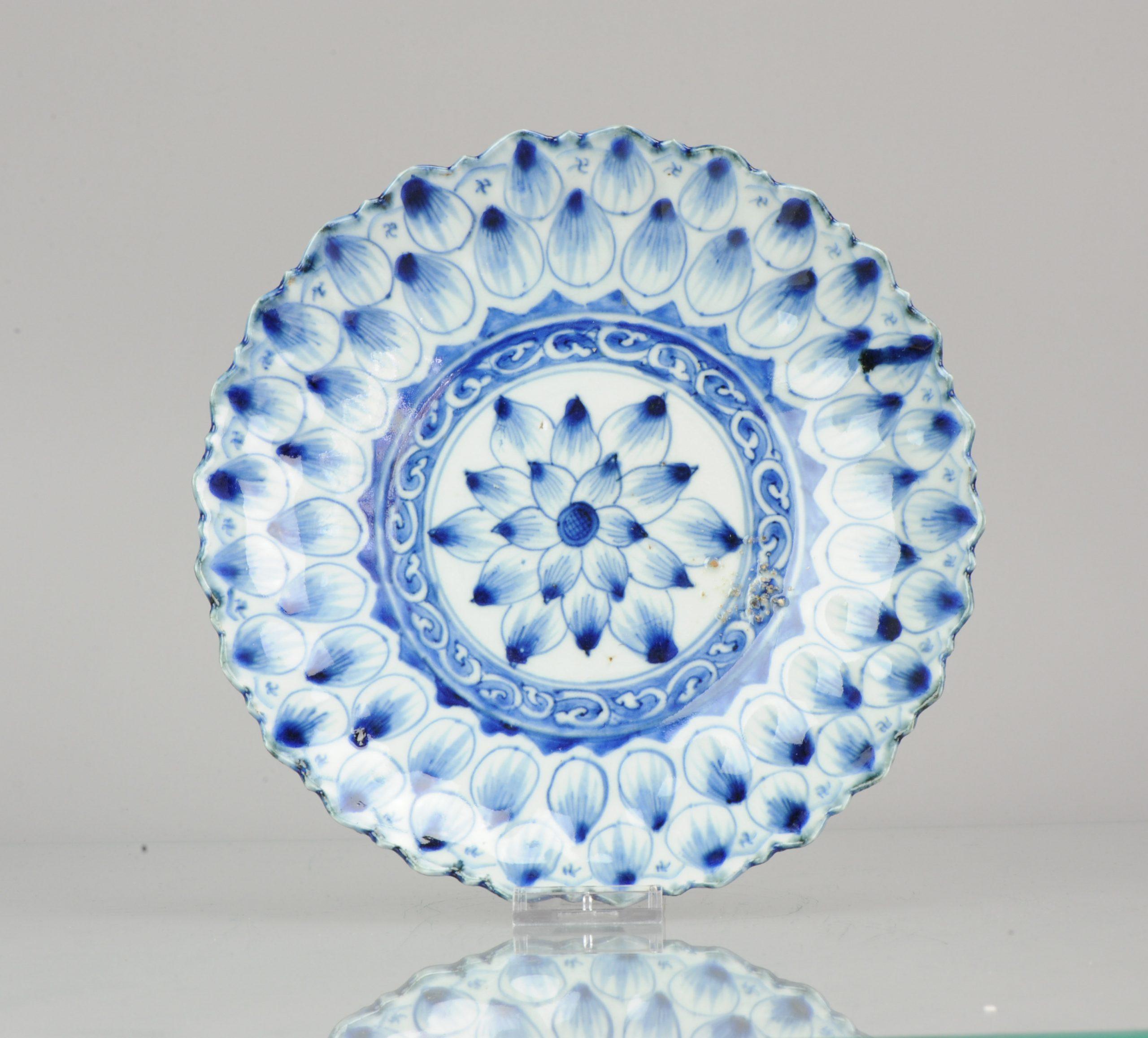 A very nice blue and white lotus shaped plate. With swastikas in the border. Chenghua marked.

Reference see:
Kyoto Shoin - Kosometsuke & MArchant - Ming porcelain for the Japanese MArkets

S. Marchant & Son: Ming Porcelain for the Japanese