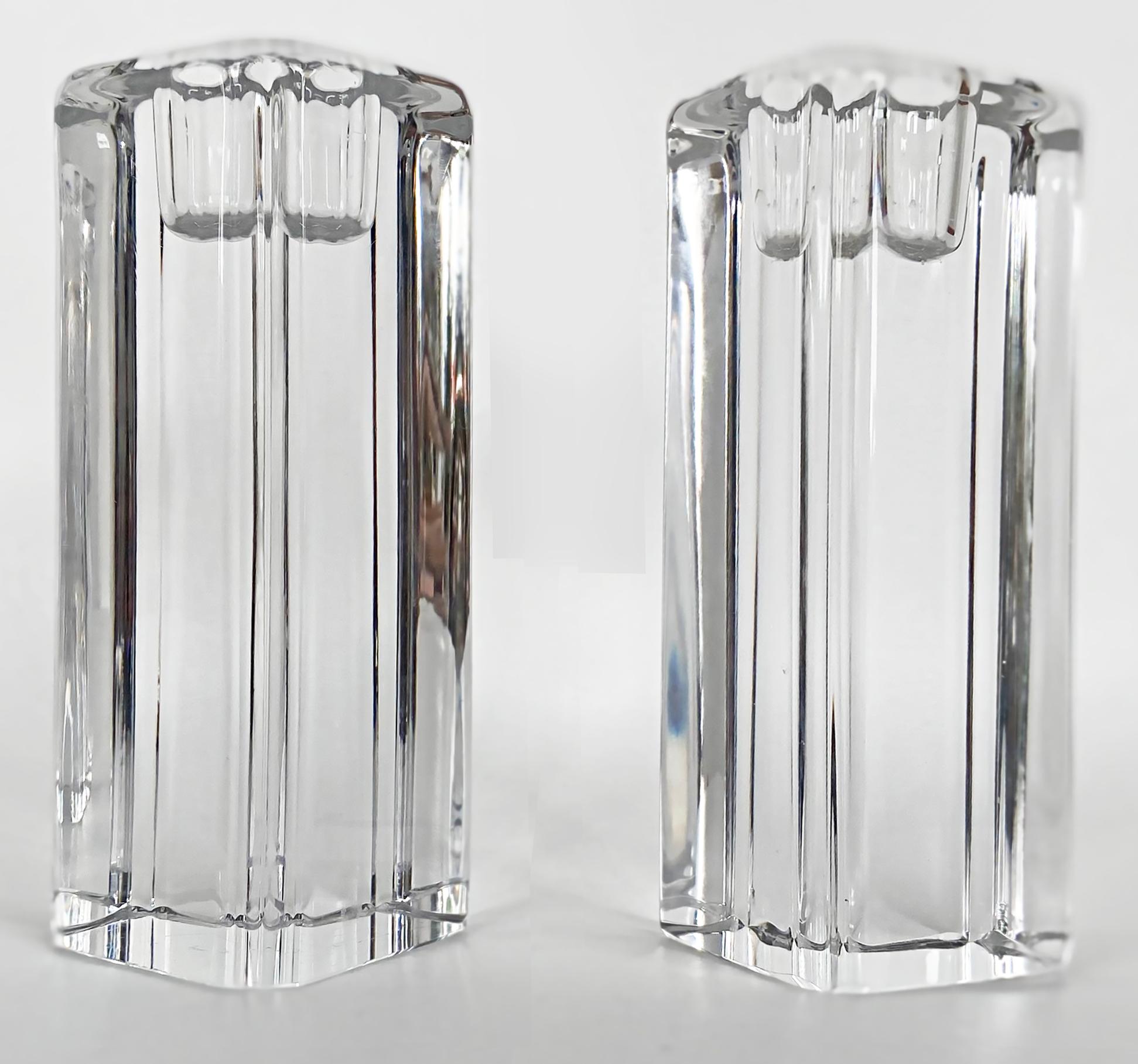 Kosta Boda Anna Ehrner tall crystal candle holders, pair

Offered for sale are two tall block-style candle holders in clear crystal, signed Kosta and Ehrner underneath on the bases. Each base is handsigned with Kosta, the model number and