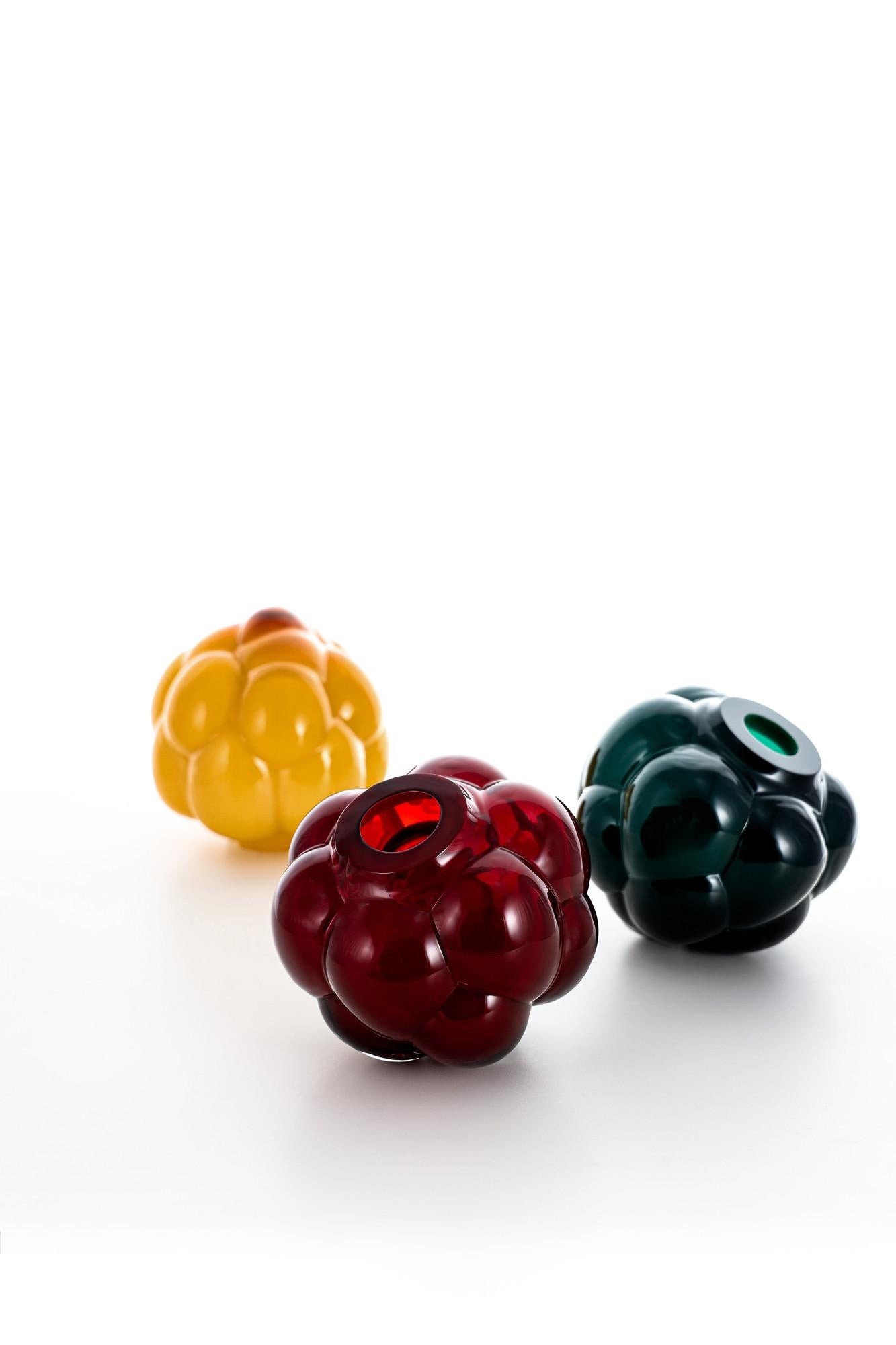 Ellen Ehk Åkesson is a Swedish glass artist who tells stories of the mysterious forest through her art glass, such as Berry Tales – a bubbling, bulbous berry plucked directly from the woodlands in her mind. The object in amber is handmade, with a