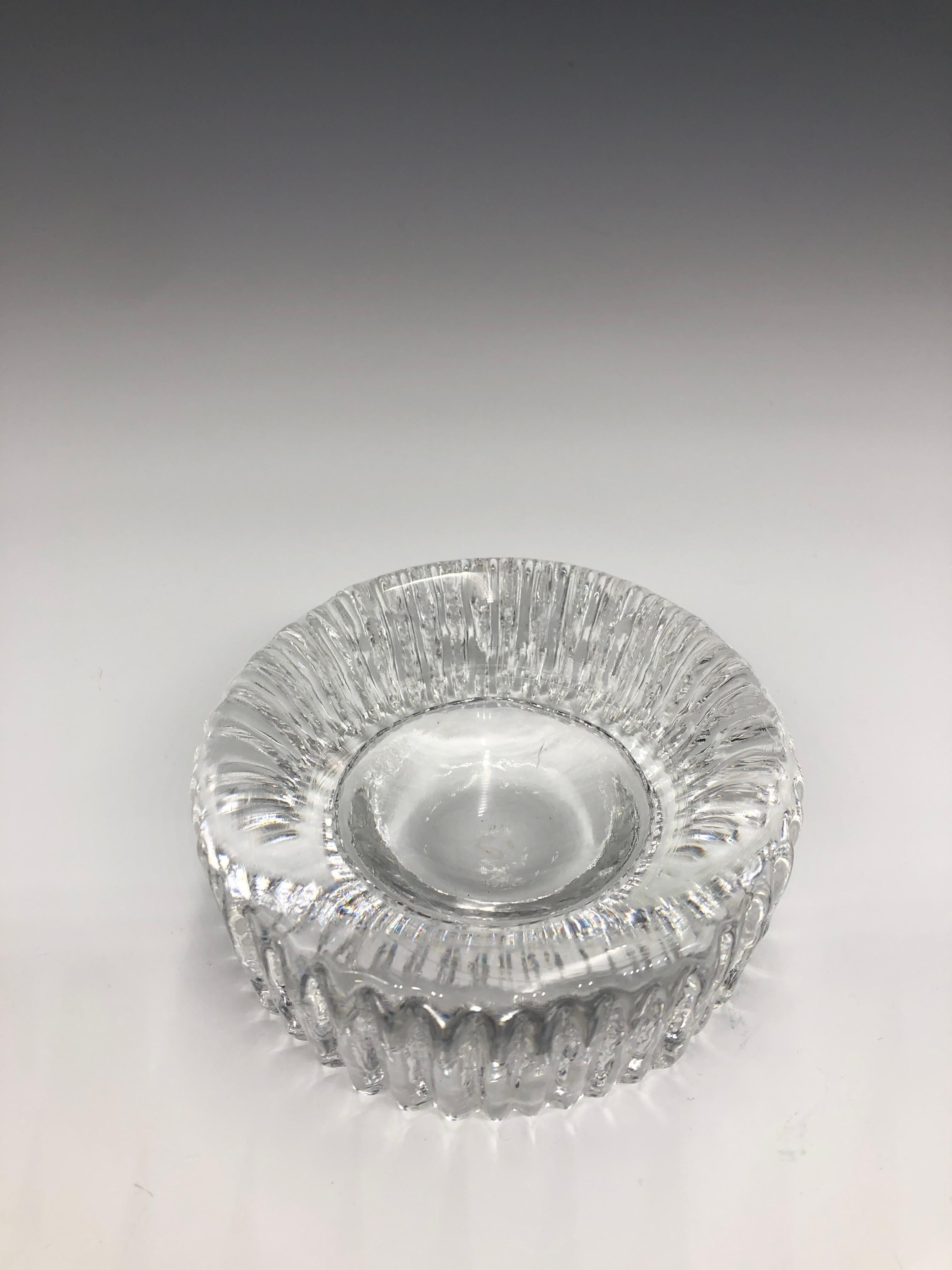 Stunning Mid-Century Modern Scandinavian 1950s Kosta Boda Rurik clear round textured ashtray in great vintage condition. No chips or cracks. 

Glass has a nice weight to it —minimal wear commensurate with age and use. It can be used as an ashtray, a