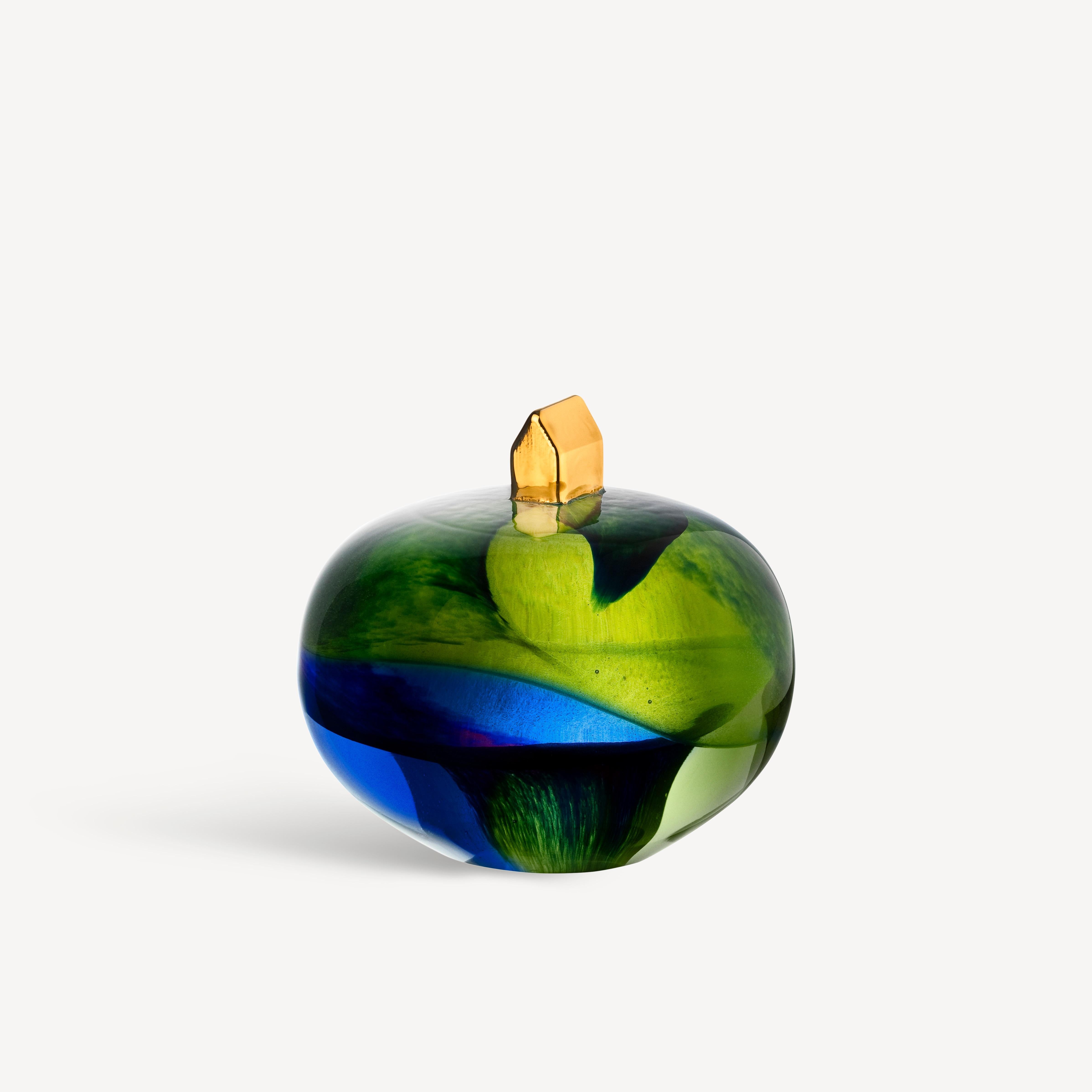 With Earth Home, the renowned glass artist Bertil Vallien has created a miniature world inspired by our place on the planet. The object in clear glass is colored light green and blue and has a small house, hand-painted with real 21 karat gold, at