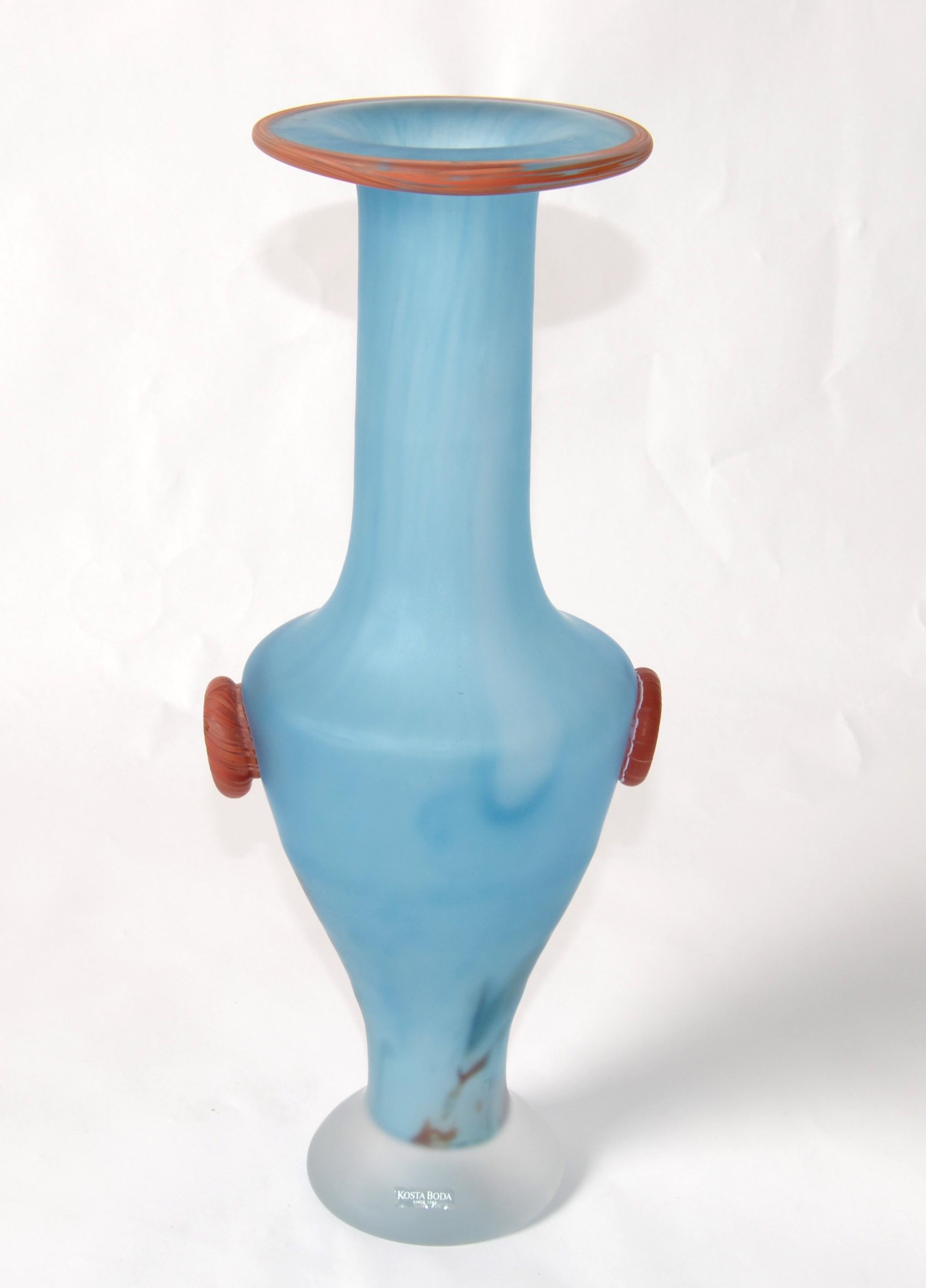 Scandinavian Modern Kosta Boda blown frosted glass vase, Vessel by Monica Backström Wedding Pandora Series. 
This blue frosted art glass vase features Bronze Rose accents with a wide rim, tapered neck, and footed base.
Makers Mark at the base and