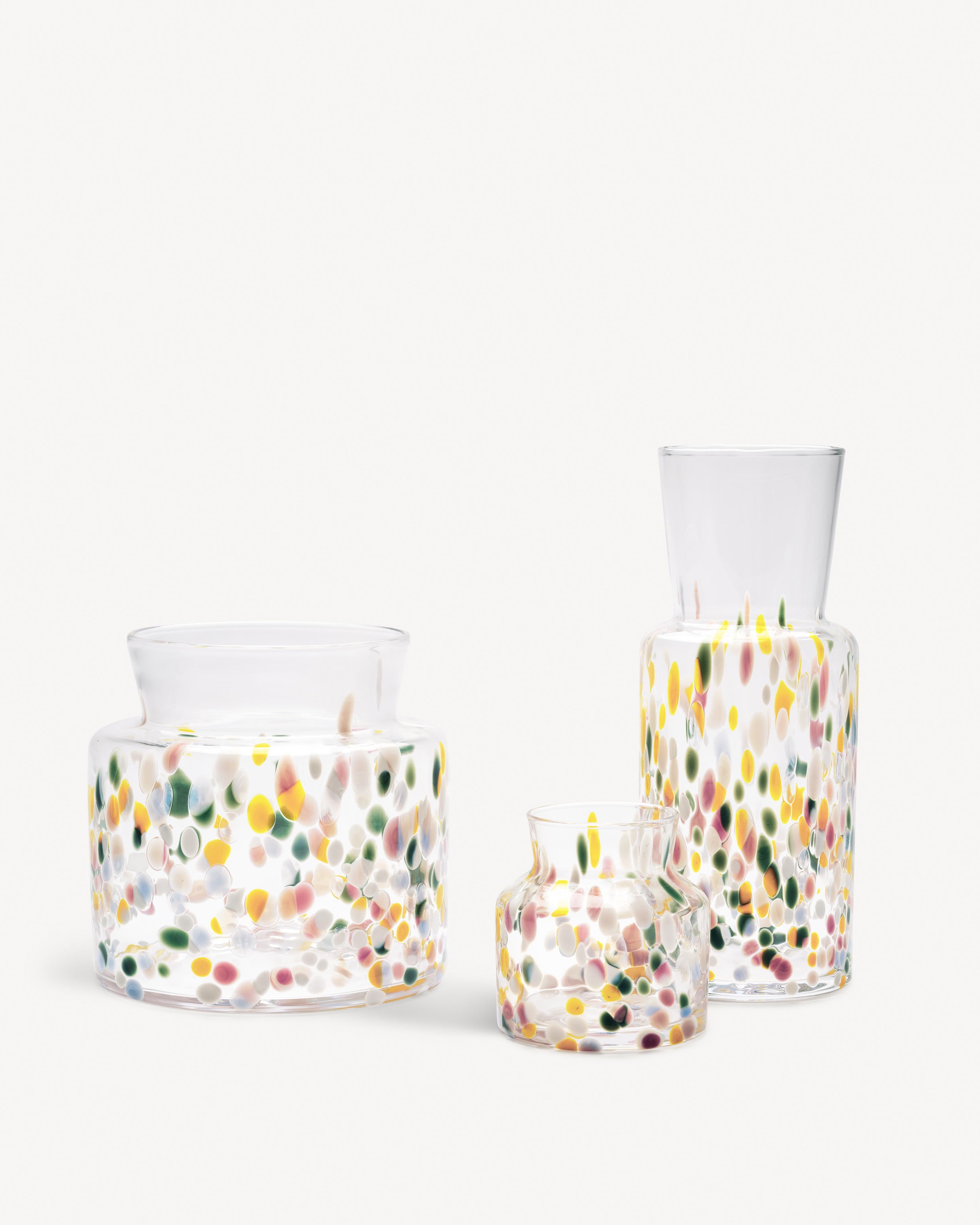 Meadow Spring is as colorful and lively as a flower meadow that comes to life during the first sunny days of spring. During the production the vases are rolled in crushed pieces of colored glass, which makes each vase unique. The small vase from