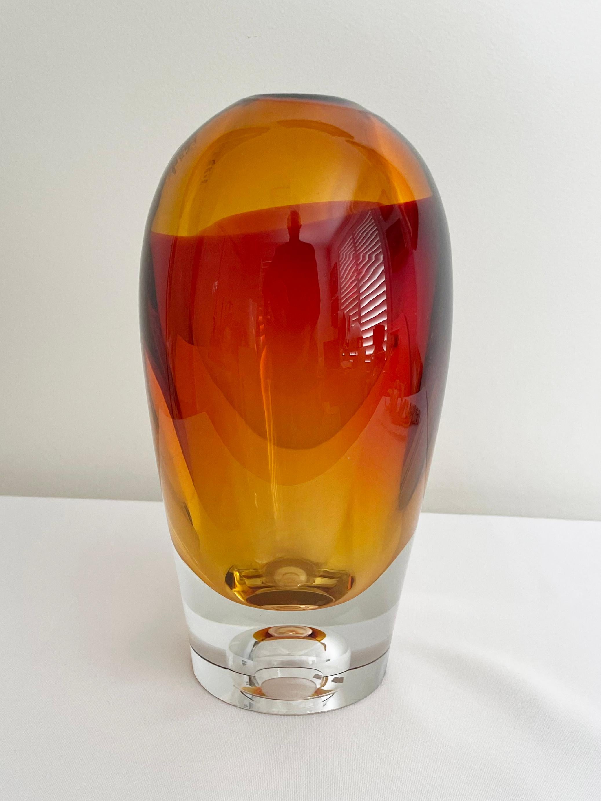 Kosta Boda orange Vision series vase designed by the legendary glass artist Göran Wärff.

Vision is handblown at Kosta Glassworks in Sweden and is part of the Kosta Boda Artist Collection.