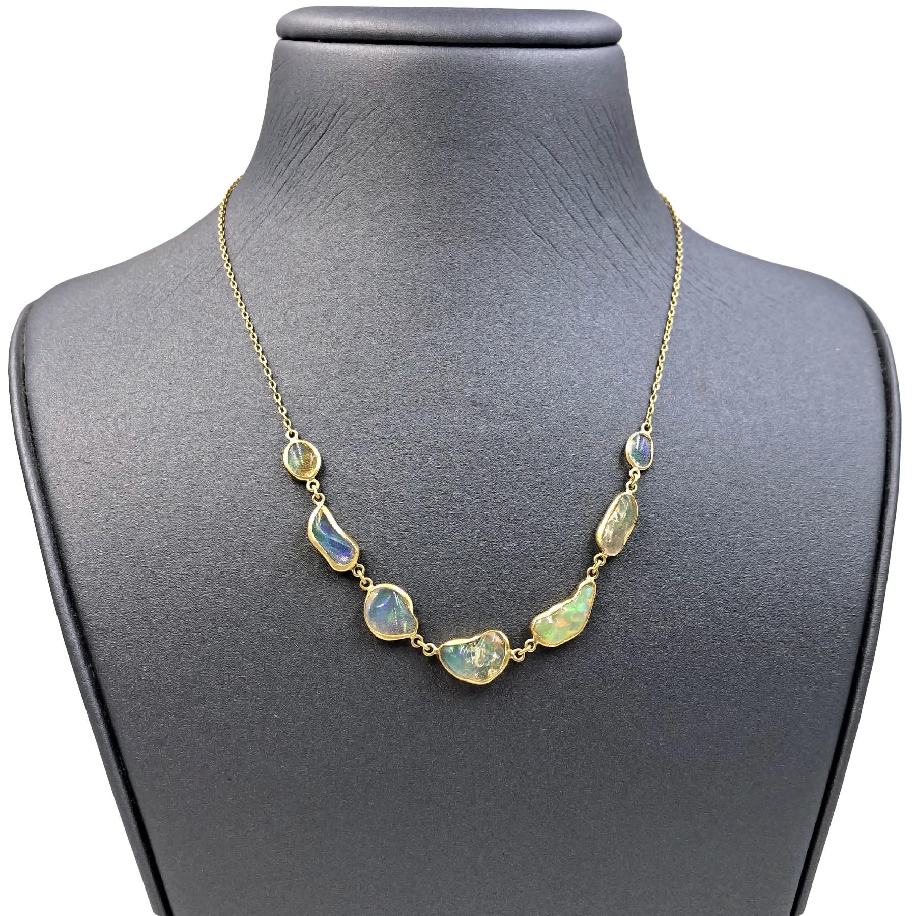 One of a Kind In-Line Necklace handmade by jewelry maker Tej Kothari in matte-finished 18k yellow gold featuring seven freeform Mexican opals with beautiful rainbow fire individually bezel-set and attached to an 18k gold chain, wearable at 16, 17,