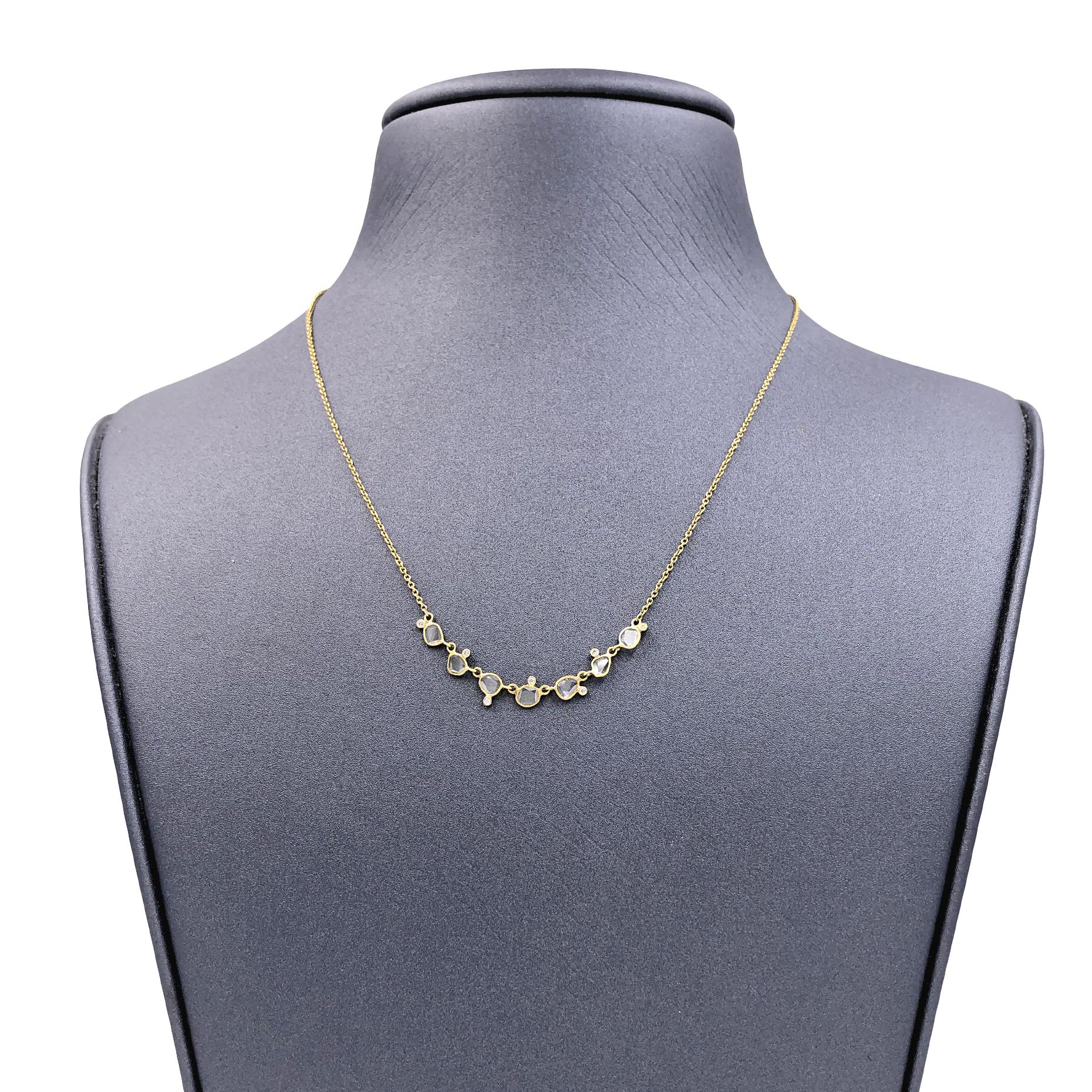 Curved Diamond Bar Necklace handcrafted by jewelry maker Tej Kothari in matte-finished 18k yellow gold featuring seven shimmering polki diamonds totaling 0.32 carats accented with 0.04 total carats of round brilliant-cut white diamonds. Worn at 16,