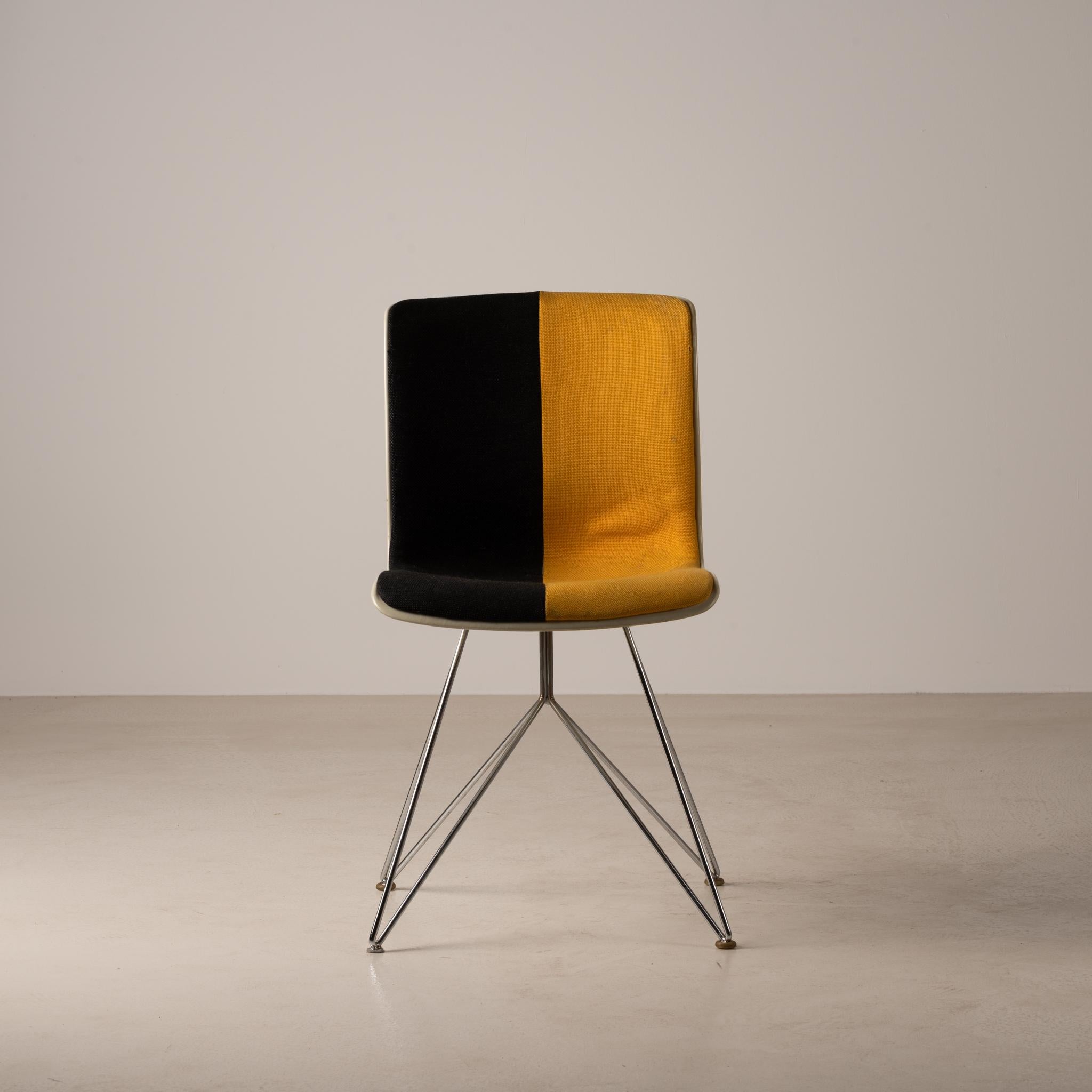 Designed in 1969 by Sori Yanagi, the Kobotuki chair has a comfortable FRP shell seat, steel plated legs and original black and yellow upholstery.

Back in the 1960s, this chair was used in public buildings such as libraries. In recent years, its
