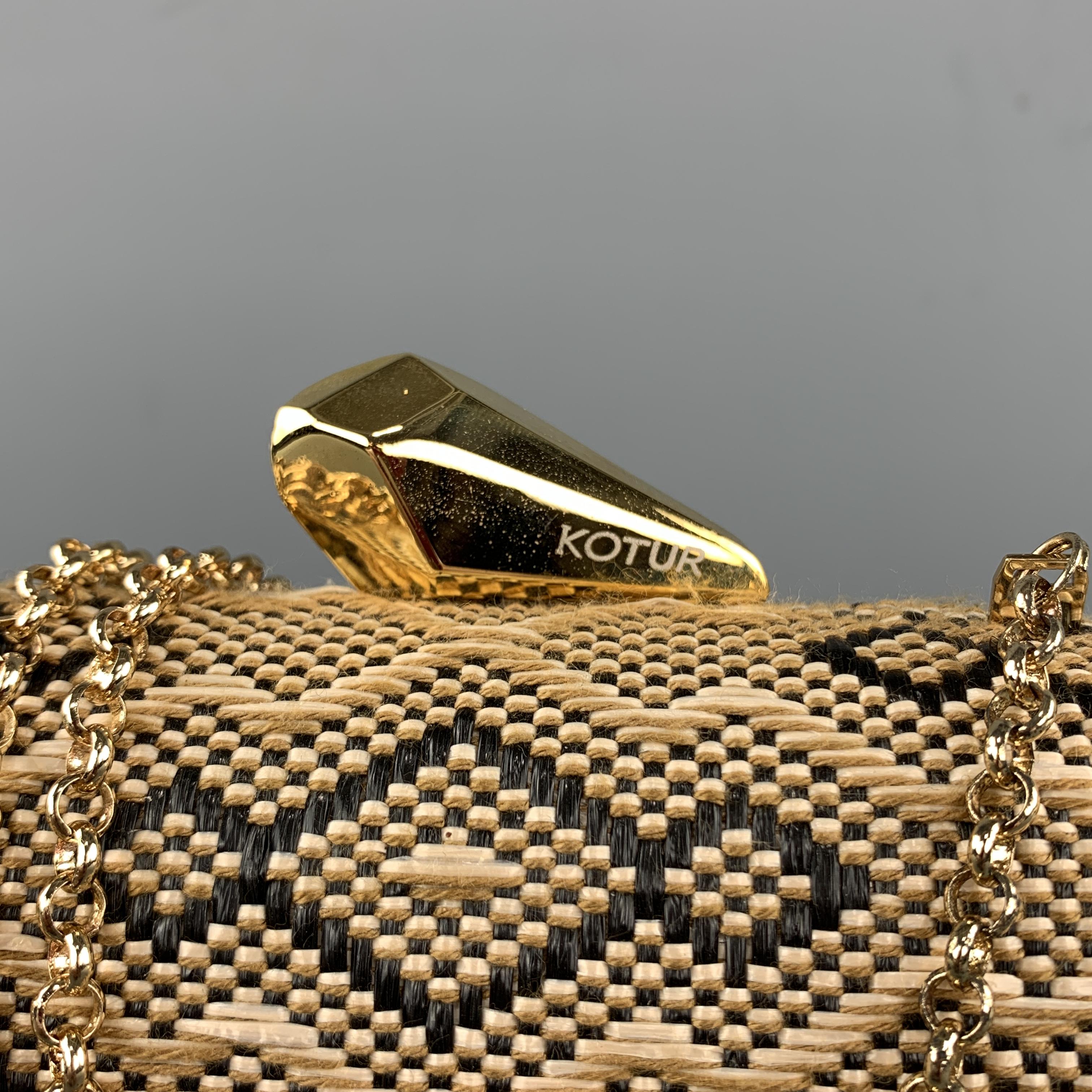 KOTUR Handbag comes in beige and black tones in a fabric woven material, with a gold chain, a gold metal tone hardware at closure, and a inner pocket.
 
Excellent Pre-Owned Condition.
 
Measurements:
 
Length: 6.5 in.
Width: 2 in.
Height: 4.5 and