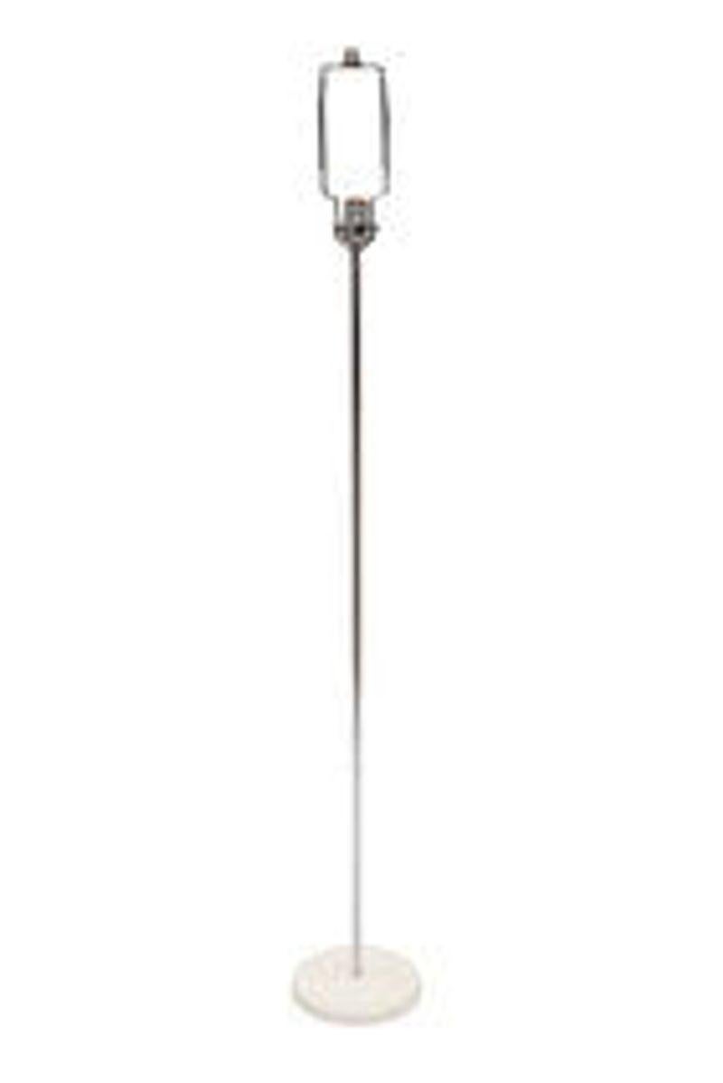 USA, 1970s
Kovacs floor lamp with round white base and chrome stem, paired with a natural linen folded empire shade. The shade adds just the right amount of interest to the minimal floor lamp. 
CONDITION NOTES: Original wiring is in working
