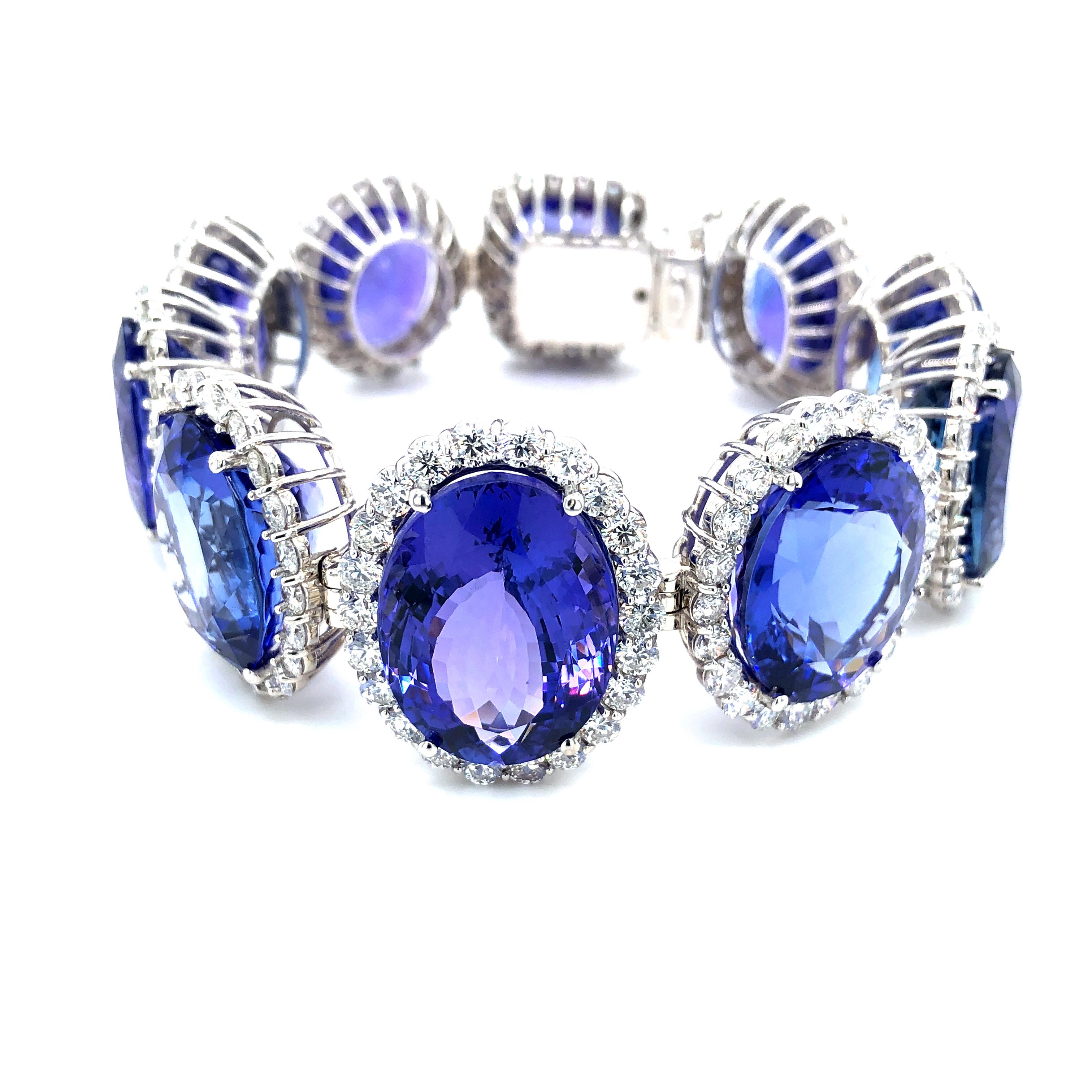 Offered here is a Kozi Collection in-house made tanzanite and diamond bracelet set in 18kt white gold. The bracelet consist of ten ( 10 ) natural tanzanite with halo brilliant cut diamonds around it. Every link was carefully measured for each