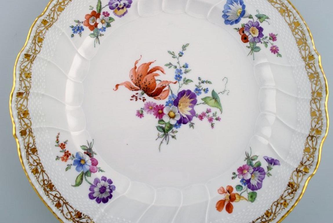 KPM, Berlin. Large antique plate in curved porcelain with hand-painted flowers and gold decoration. 
Late 19th century.
Diameter: 28 cm.
In excellent condition.
Stamped.
 