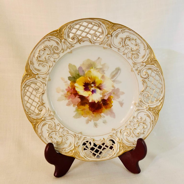 I am offering you this fabulous KPM fluted cabinet plate with gold and white intricate reticulation. There is a beautiful painting of a bouquet of pansies on the center of the plate on a white porcelain ground. This plate is really a work of art. It