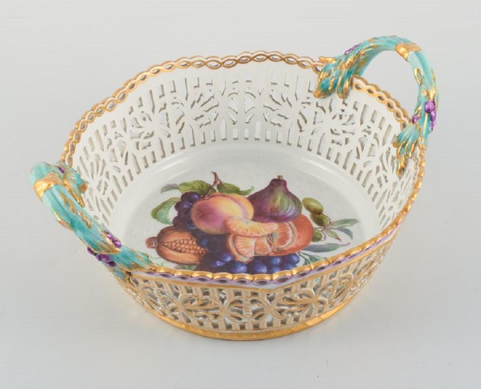 KPM, Germany. Large impressive, openwork bowl in porcelain. 
Hand-painted with fruits.
Handle in the form of branches.
Painted outside the factory in 1910.
Measuring: D 31,0 cm. Including the handle, H 14.0 cm. Including the handle.
In