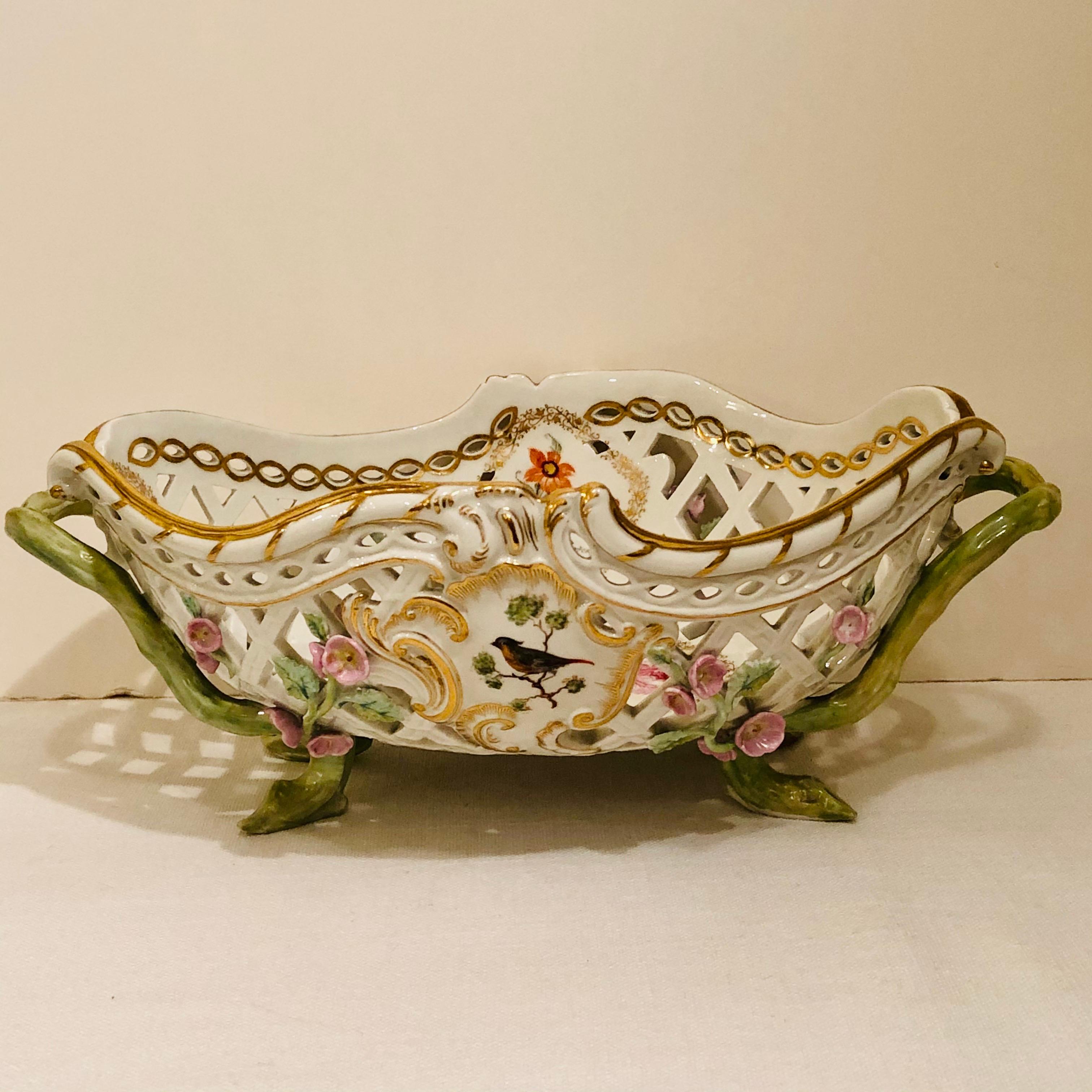 This is a fabulous KPM bowl beautifully decorated with reticulation and raised pink flowers. Each side of the KPM bowl is painted with a different bird painting. The inside of the bowl is painted with five different medallions of flower bouquets as