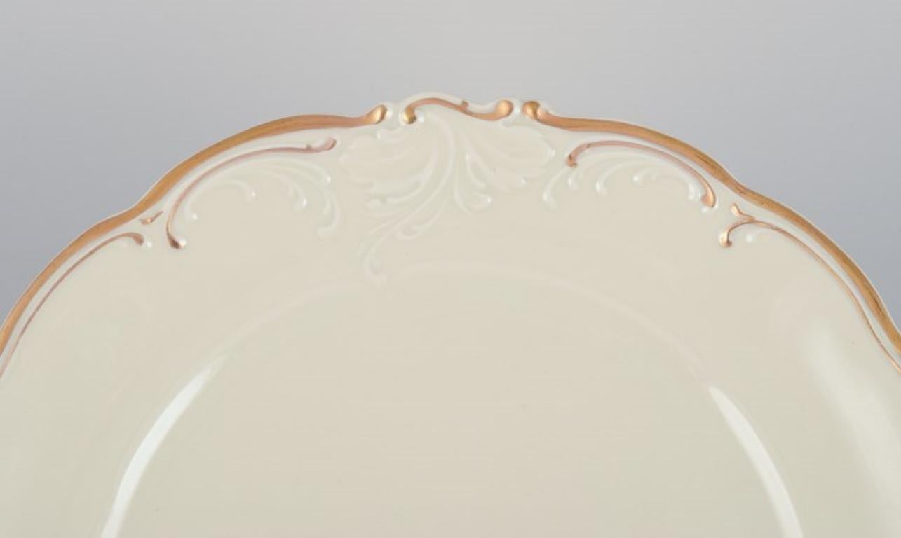 Polish KPM, Poland. A set of five dinner plates in cream-colored porcelain.  For Sale