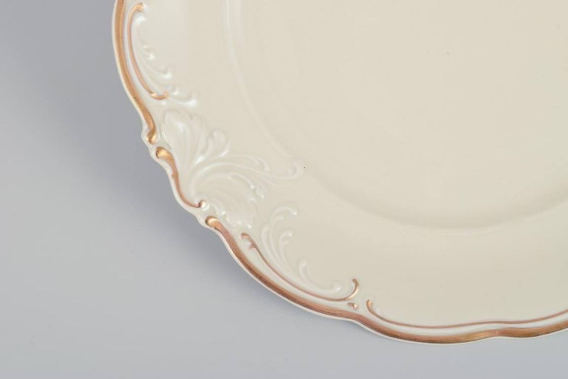 Mid-20th Century KPM, Poland. A set of five dinner plates in cream-colored porcelain.  For Sale