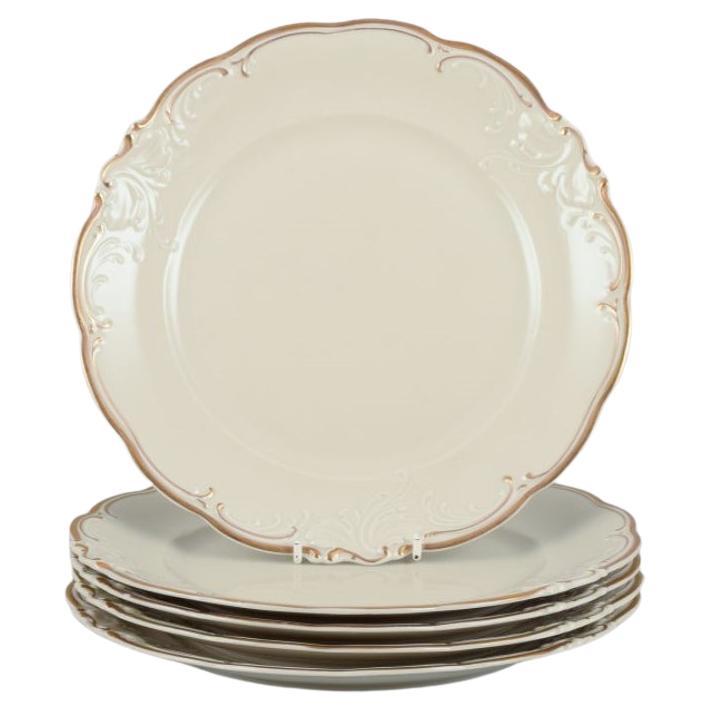 KPM, Poland. A set of five dinner plates in cream-colored porcelain.  For Sale