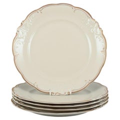 KPM, Poland. A set of five dinner plates in cream-colored porcelain. 