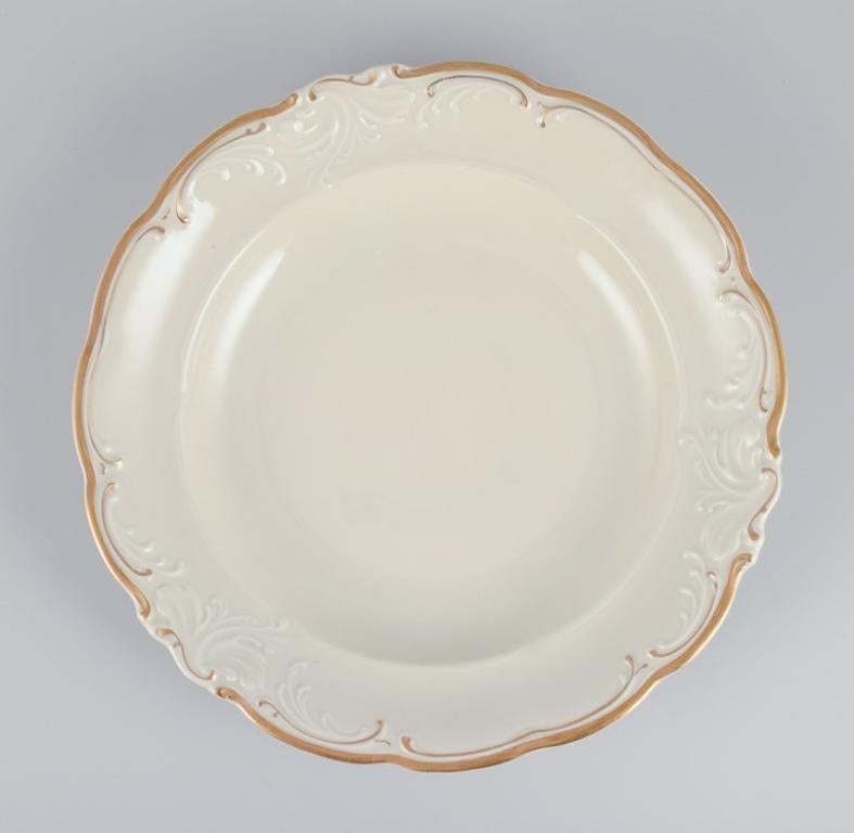 KPM, Poland. A set of five large deep porcelain plates in cream color.
Gold-rim decoration.
Classic style.
1930s/1940s.
Marked.
In excellent condition.
Dimensions: D 24.0 cm x H 3.8 cm.