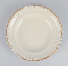 KPM, Poland. Set of five large deep porcelain plates in cream color.