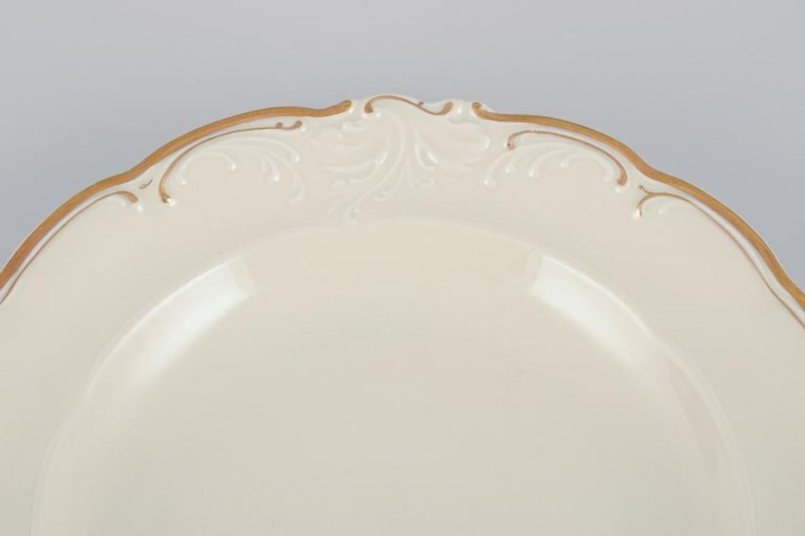 Polish KPM, Poland. Set of four large deep porcelain plates in cream color. For Sale