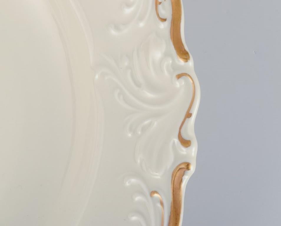 KPM, Poland. Set of four large deep porcelain plates in cream color. In Excellent Condition For Sale In Copenhagen, DK