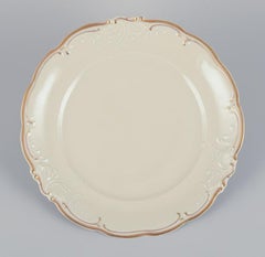 KPM, Poland. Set of six dinner plates in cream-colored porcelain.