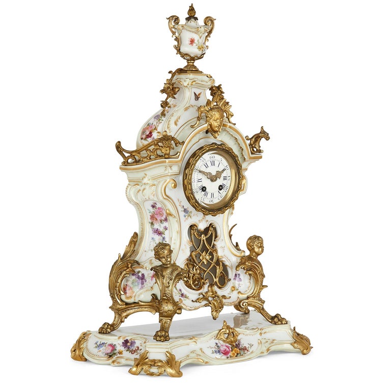 KPM porcelain and gilt bronze Rococo style clock set
German, late 19th century
Measures; Clock on base: Height 51cm, width 36cm, depth 17cm
Candelabra: Height 47cm, width 27cm, depth 27cm

This beautiful three-piece clock set features fine KPM