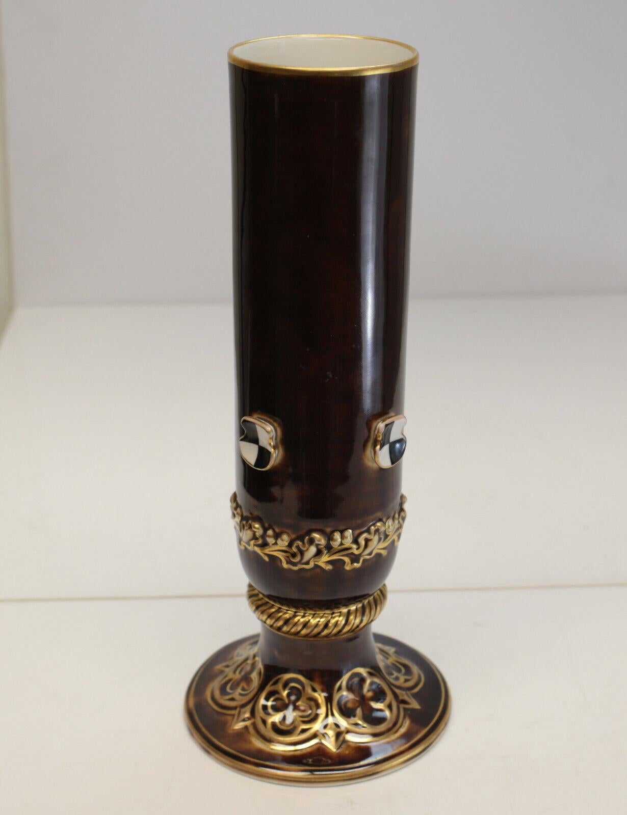 KPM Porcelain and Gilt vase, Applied Checkered Accents, circa 1850

Brown ground to the vase that mimics tortoise shell. Gilt leaf accents around the rim of the base and applied checkers towards the bottom. KPM mark to the underside.

Additional