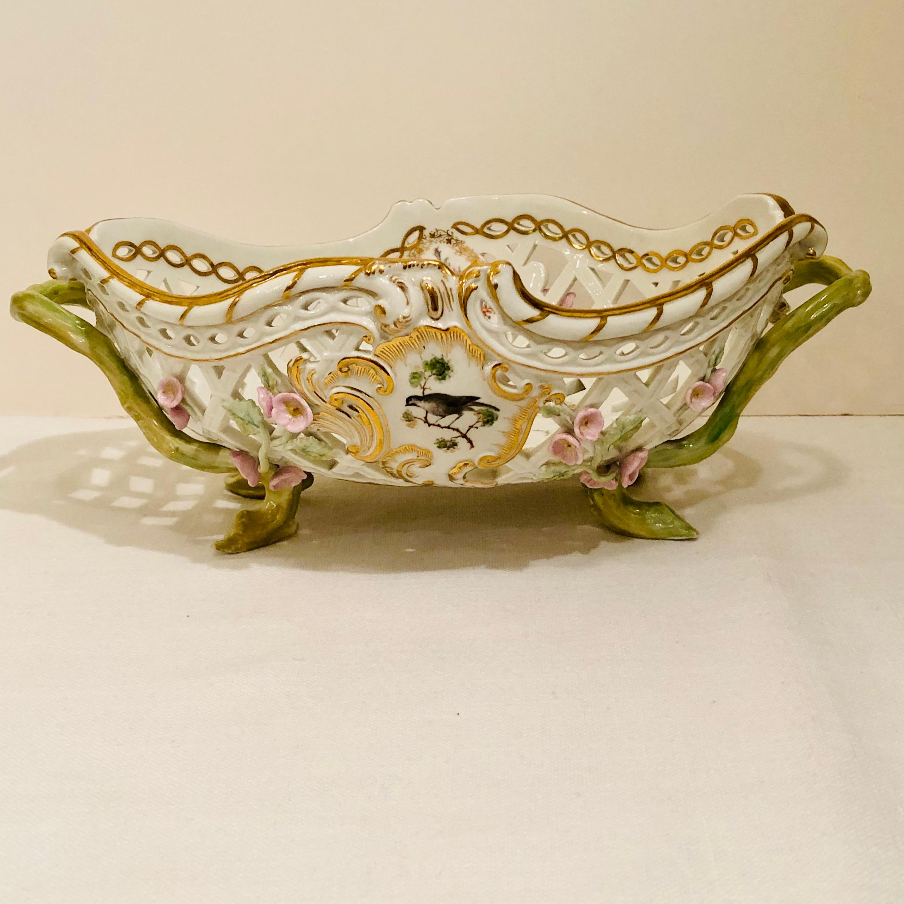 This is a fabulous KPM bowl beautifully decorated with reticulation and raised pink flowers. Each side of the KPM bowl is painted with a different bird painting. The inside of the bowl is painted with five different medallions of flower bouquets as