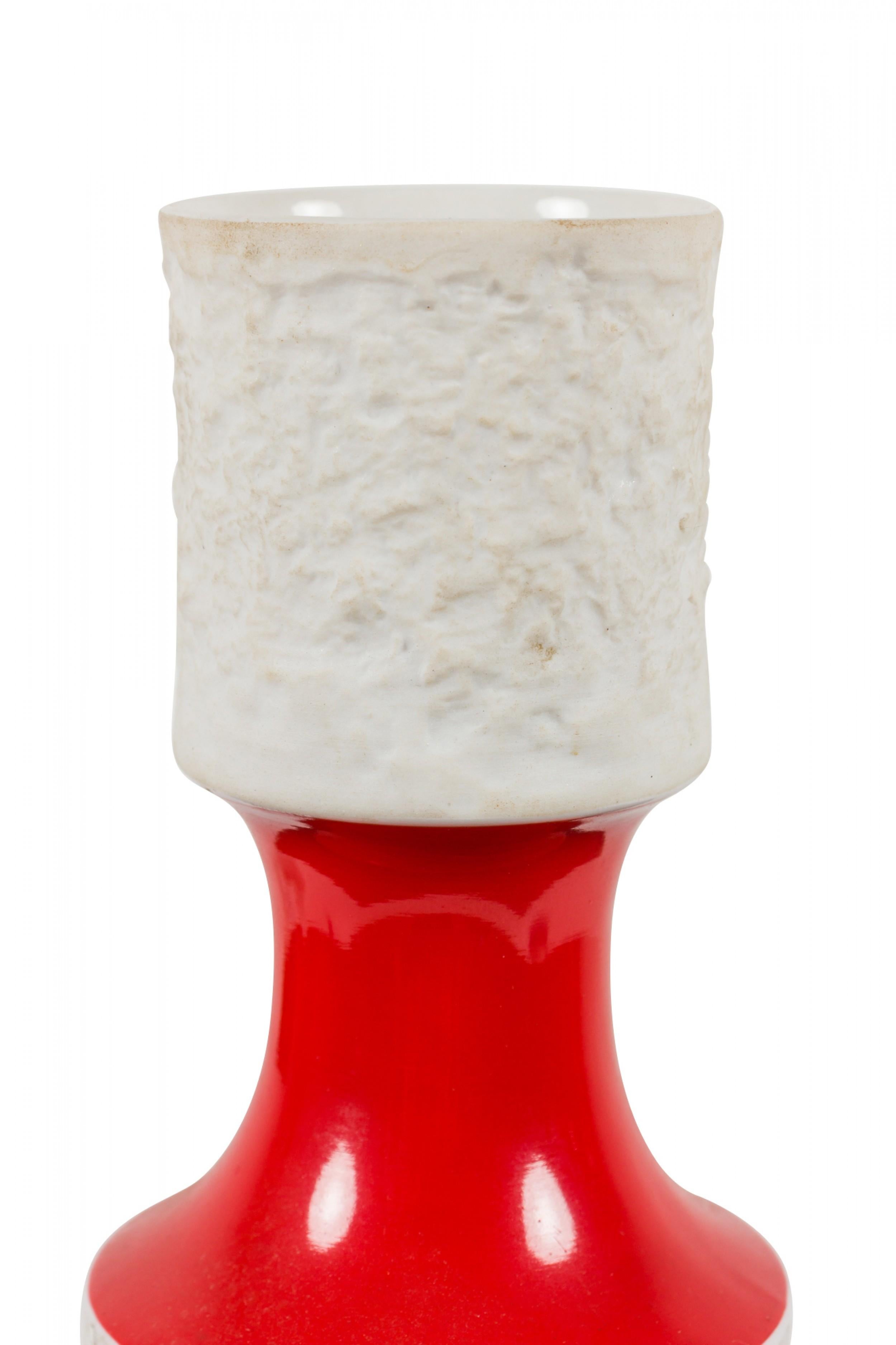 West German Mid-Century porcelain vase with a white textured cylindrical mouth and body, connected by a narrow red glazed porcelain neck. (Königliche Porzellan Manufaktur, mark on bottom, ROYAL PORZELLAN BAVARIA, KPM GERMANY, HANDARBEIT)(Similar