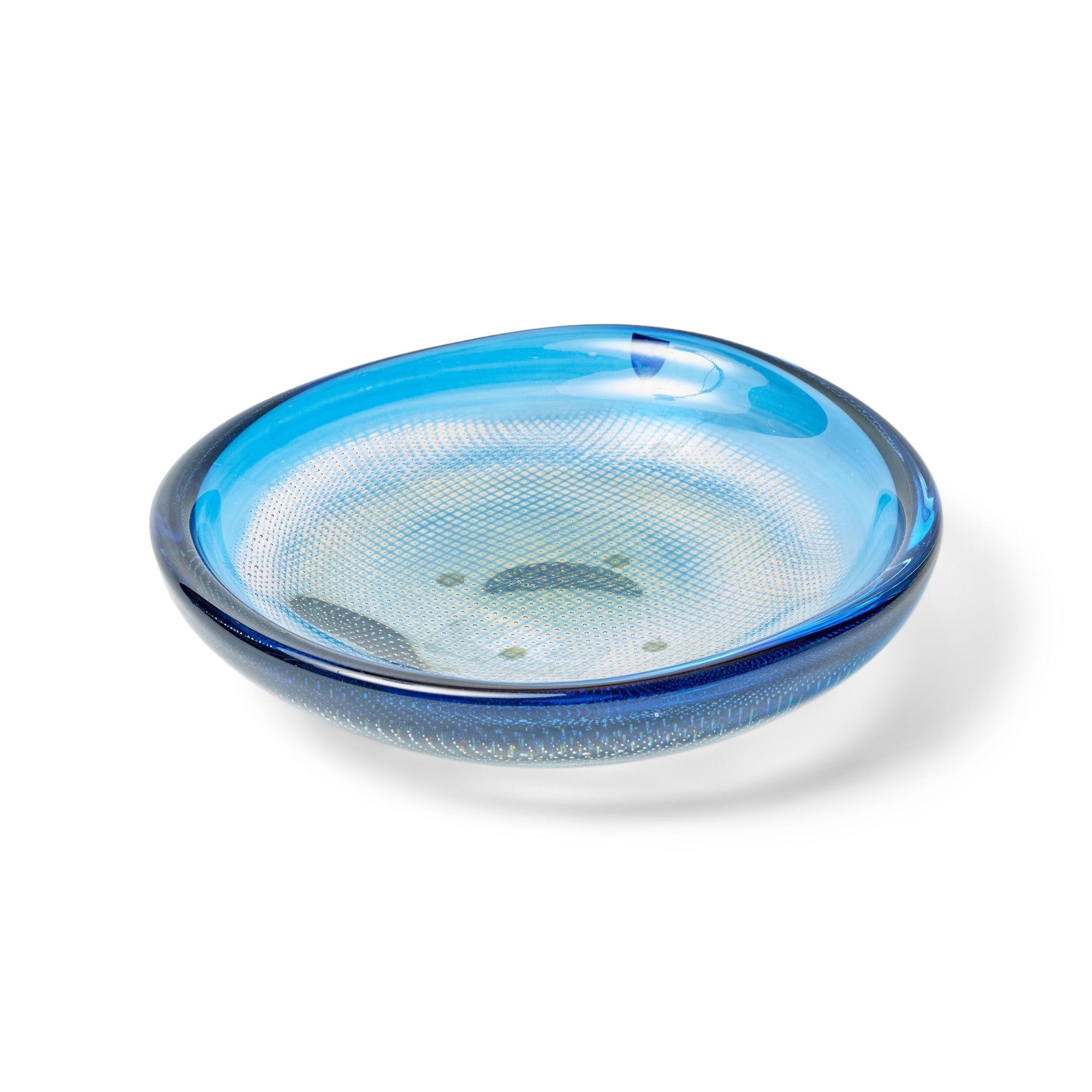 A hand blown low bowl having thick clear glass with hues of blue and yellow, showcasing an internal lattice design. Underside marked 'Orrefors Kraka P436 Sven Palmqvist'