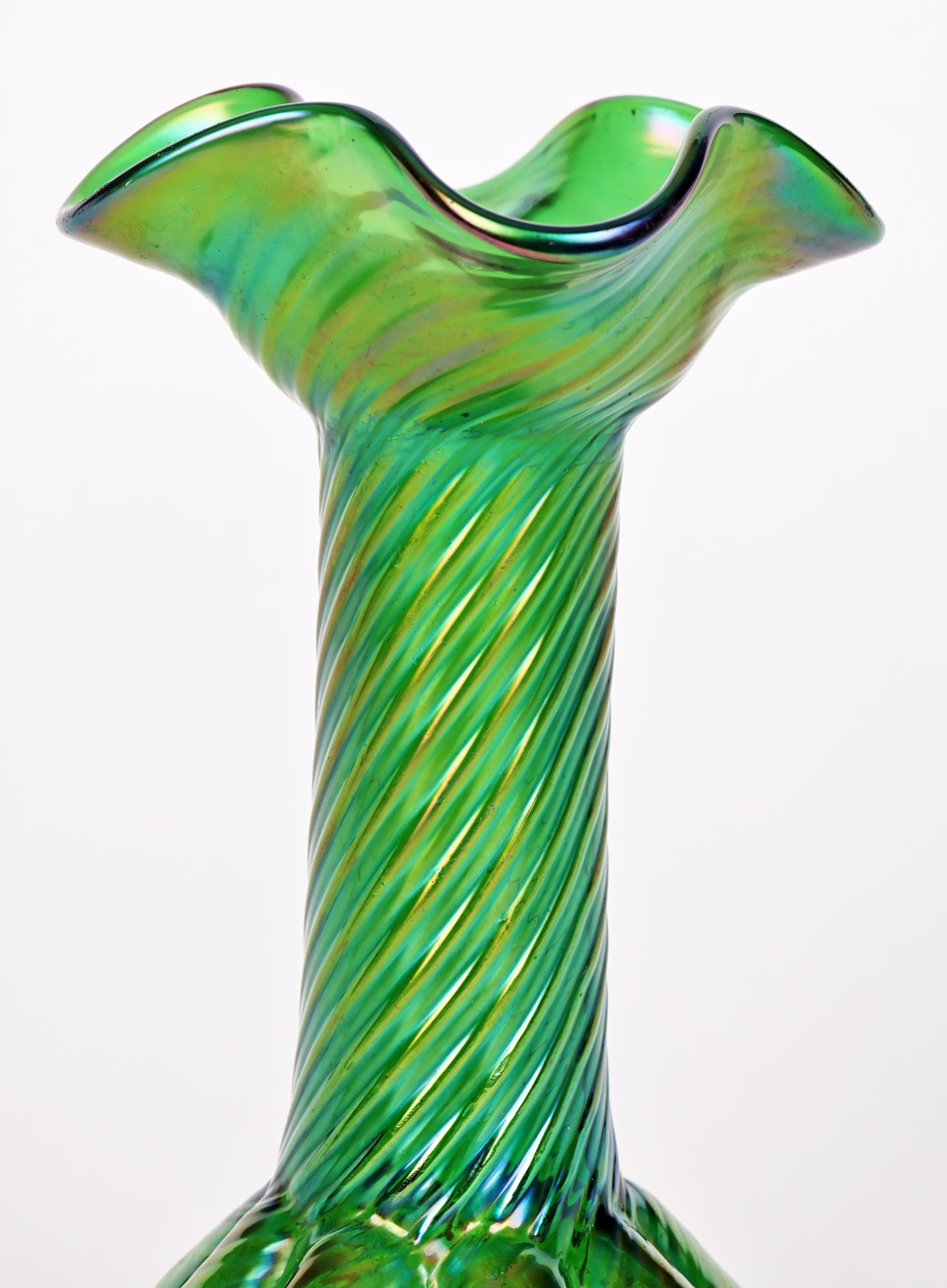 A simply stunning Art Nouveau iridescent flower bud shaped green art glass vase attributed to Kralik and dating from around 1900. The tall elegantly shaped vase is hand blown with a round eight section bulb shaped base tall slender body applied in