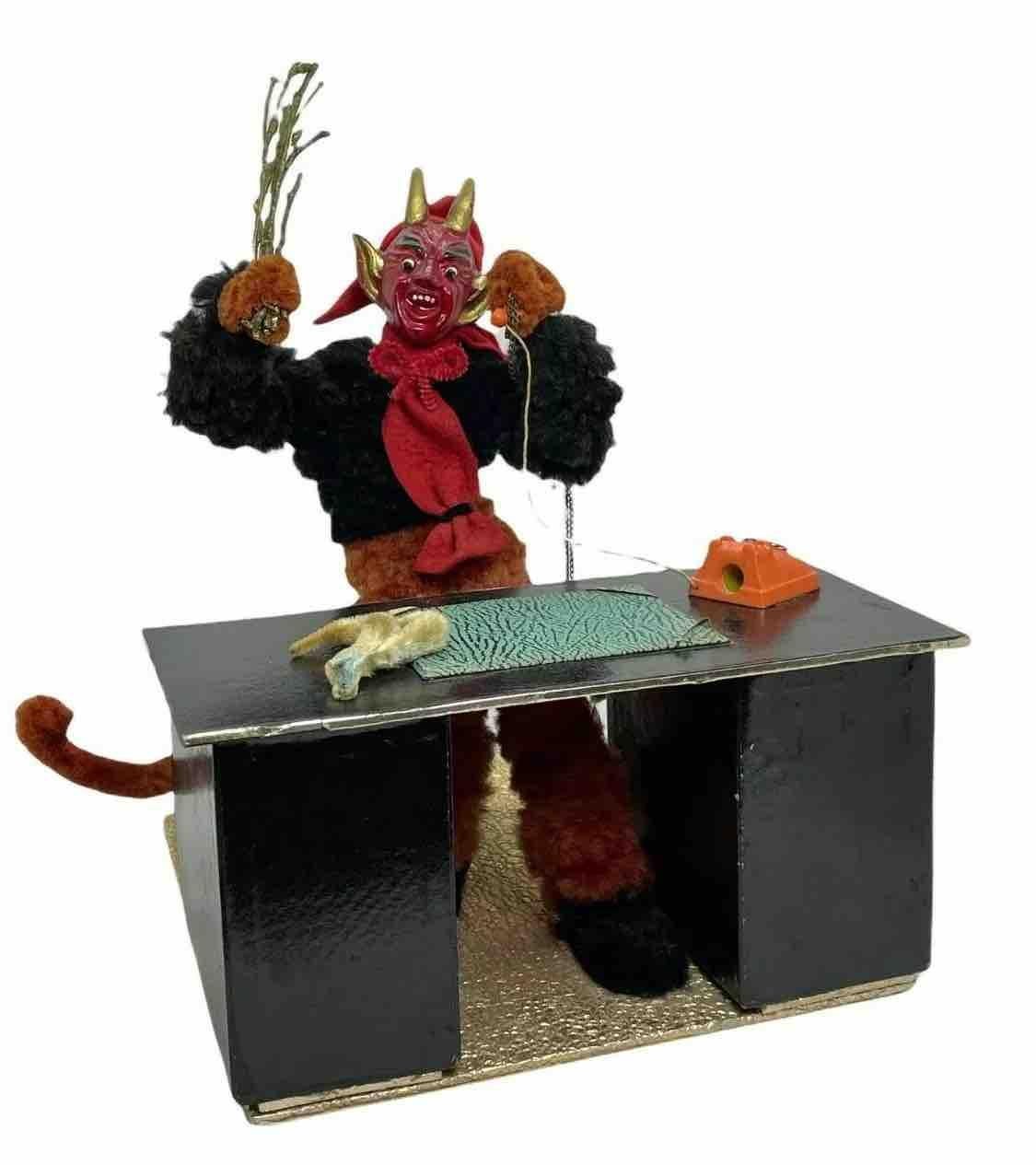 This unique Christmas figurine from Austria features a handmade figurine of the Christmas character Krampus, Belsnickel's companion. The vintage piece dates from the 1940s or older and features intricate handwork and an antique finish. Given the