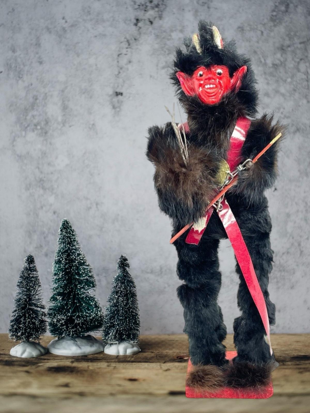 This unique Christmas figurine Candy Container from Austria features a handmade figurine of the Christmas character Krampus, Belsnickel's companion. The vintage piece dates from the 1920s or older and features intricate handwork and an antique