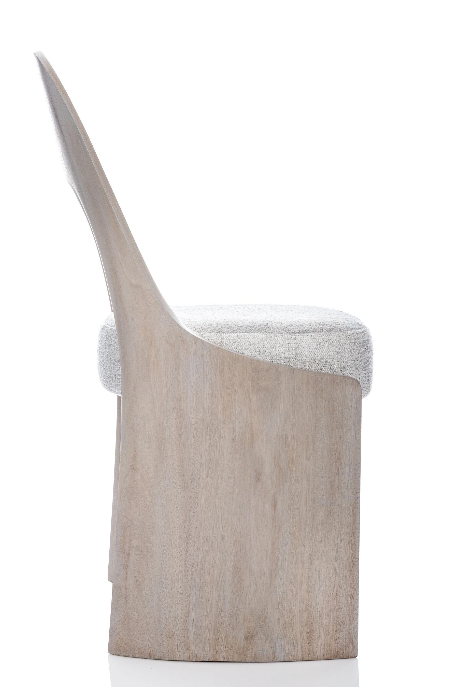 The Gaia chair is a contemporary dining or accent chair. Made of hand carved solid wood, the back has a gentle slope, conforming to the body for a remarkably comfortable experience. Its simplicity and minimalism work well with many other designs,