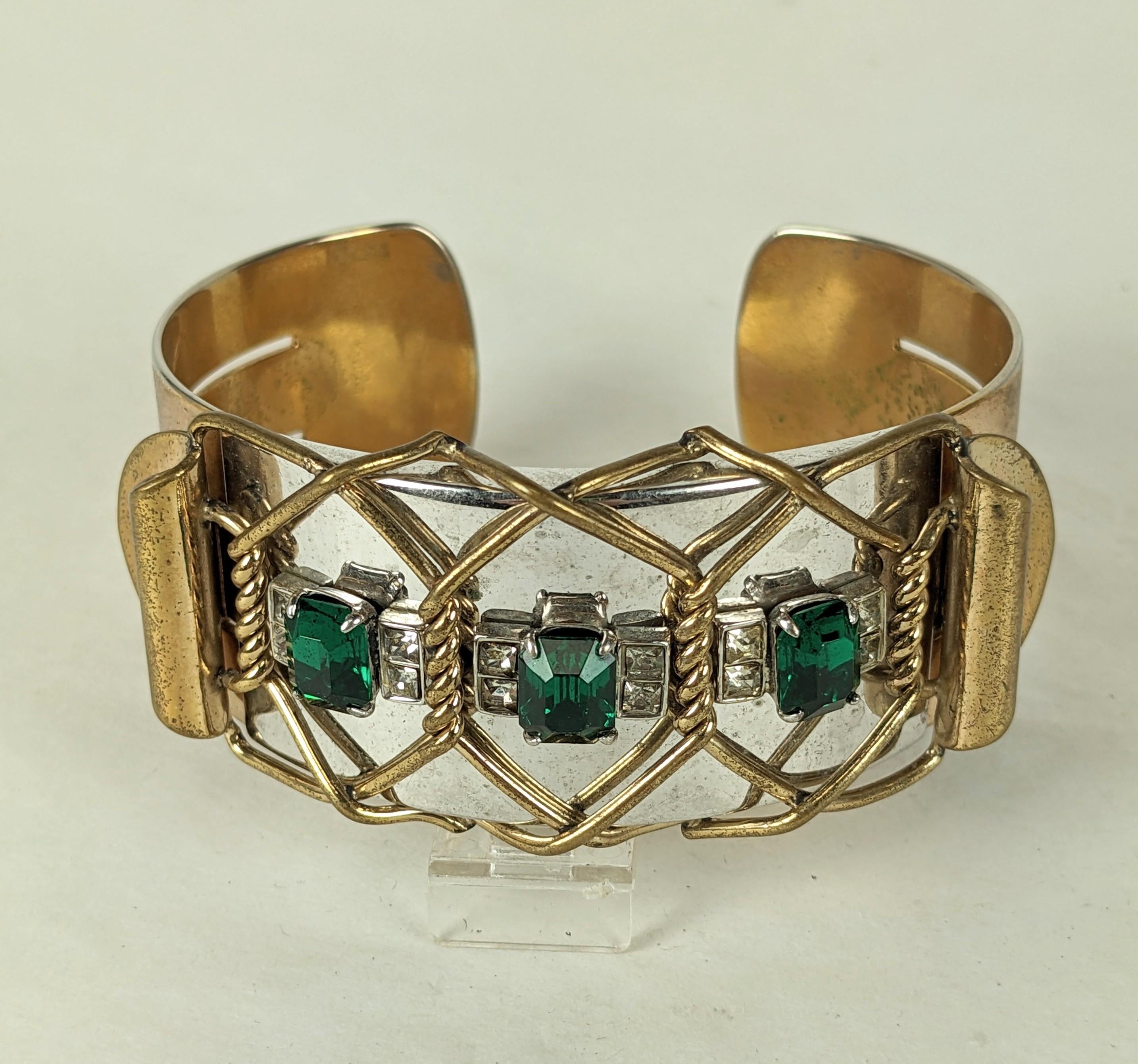 Kreisler Two Toned Retro Cuff from the 1940's. Gold and silver plated metal with a central motif of green and crystal pastes. Gilt wirework forming a barb wire effect over the silvertoned area, very striking design. 1940's USA. Signed. 
Medium size.
