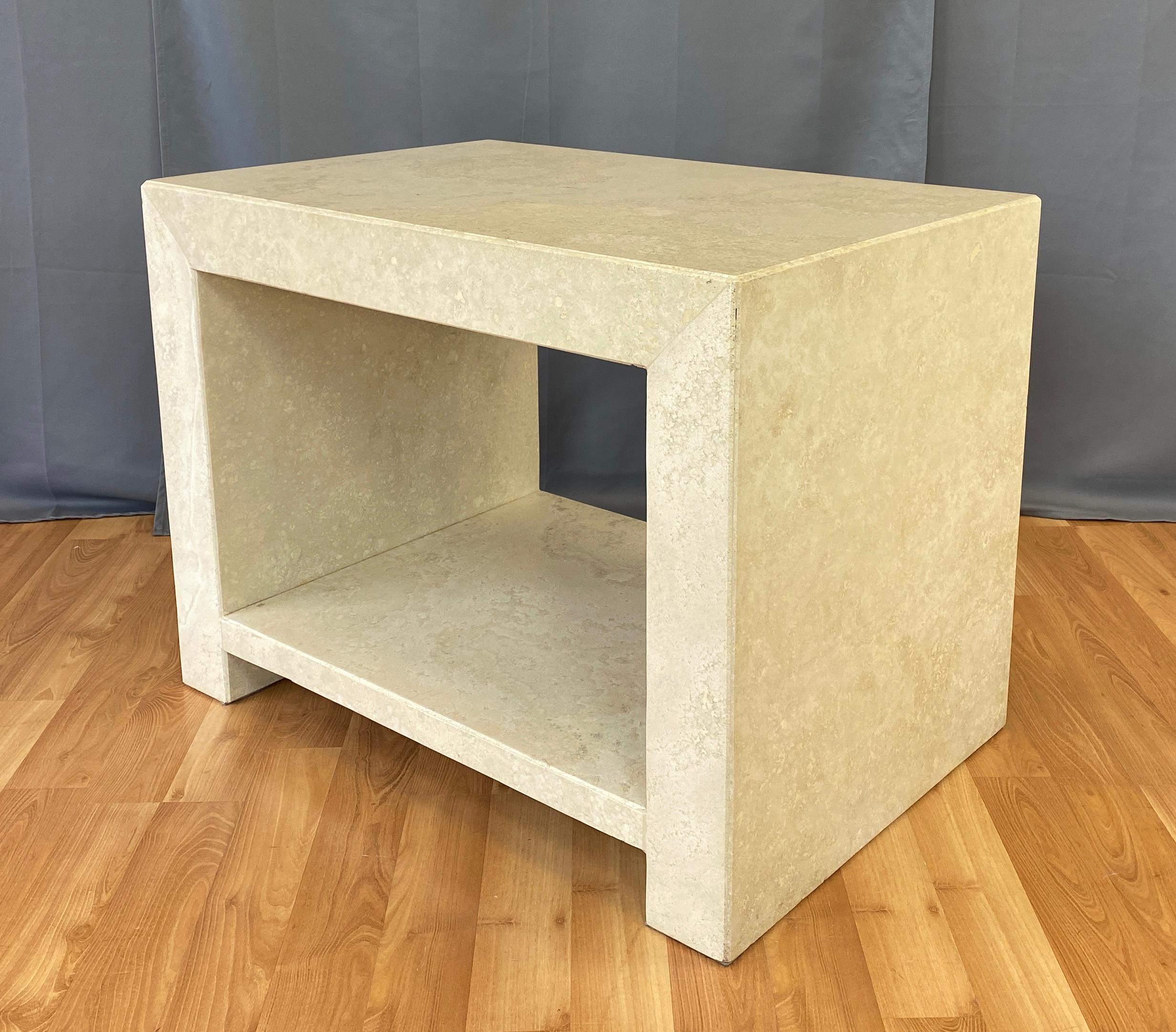 Offered here is a substantial Kreiss two-tier end table, from their Caravelle collection.
Made of travertine marble, this good size table has a nice large lower shelf for displaying items.
Finish of the travertine is smooth to the touch.