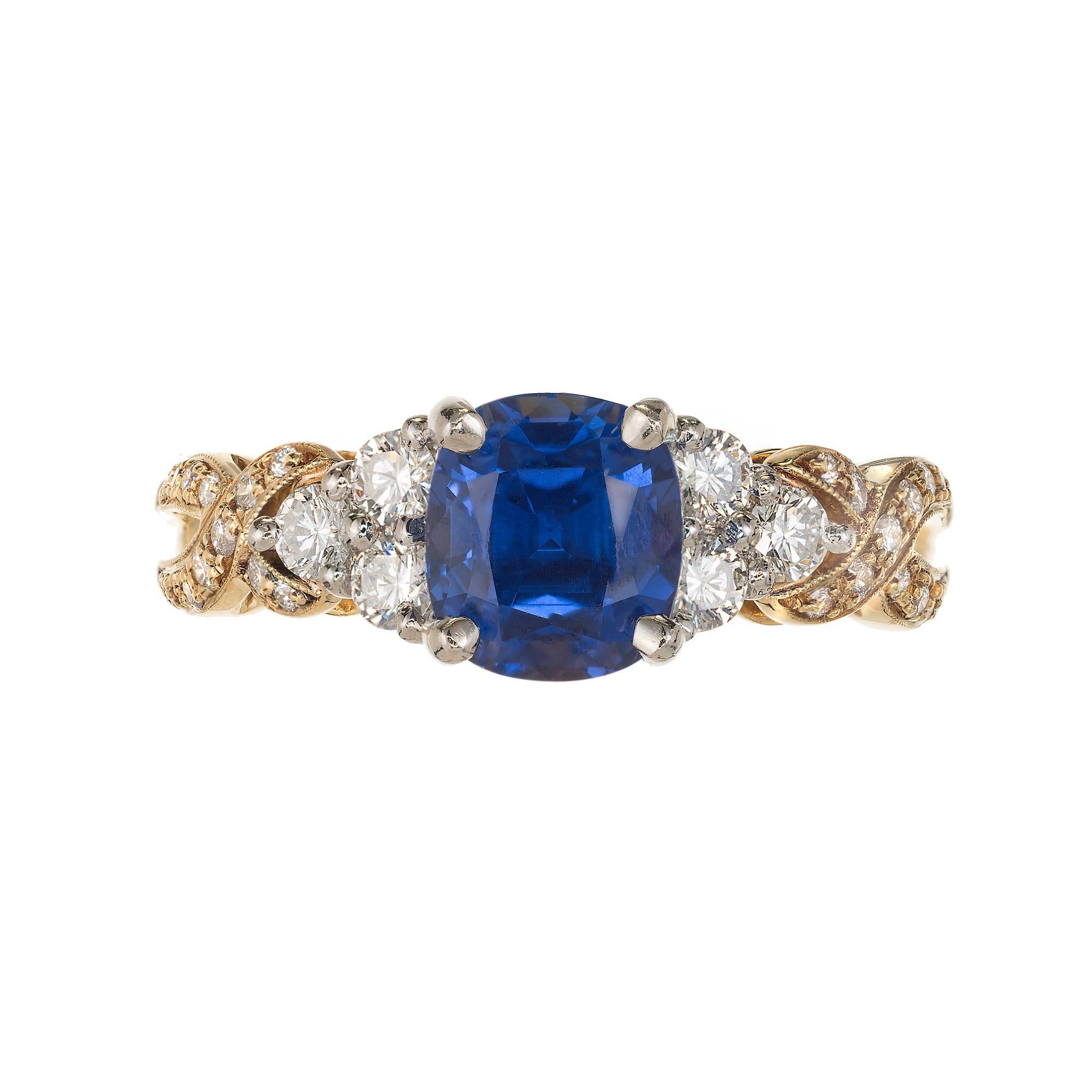 Krementz Cushion cut Sapphire and diamond engagement ring. GIA certified center stone is set in a 18k yellow gold and platinum setting with two yellow sapphires and 36 round diamonds. 

1 cushion gem blue with a hint of red Sapphire, approx. total