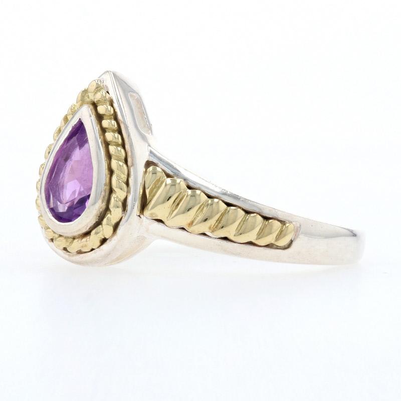 This lovely new ring is a Krementz piece composed of sterling silver with 18k yellow gold accents. The ring features a teardrop setting with a bezel set genuine amethyst displayed at the center. The setting is framed by 18k scalloped designs which