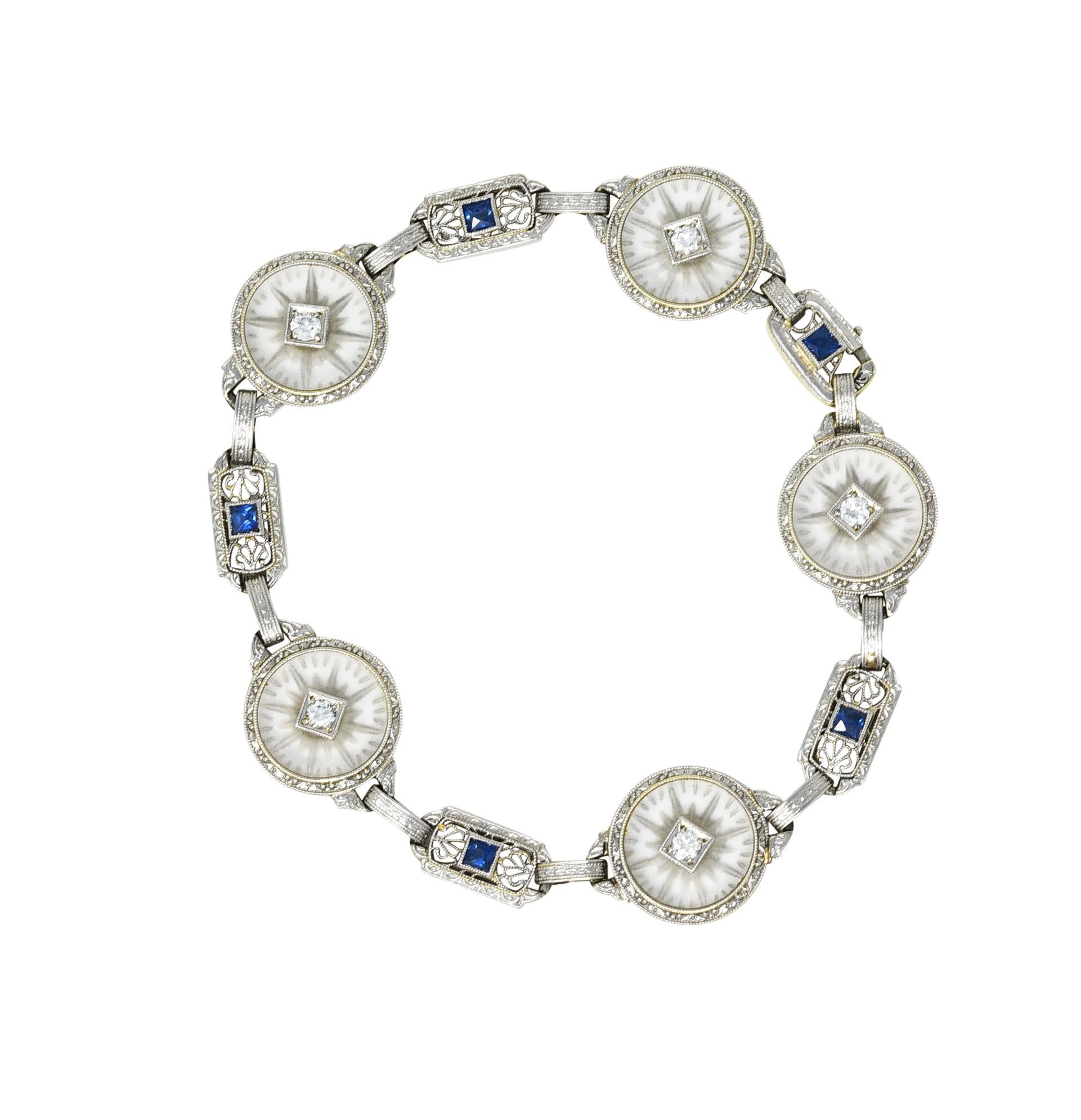 Bracelet designed as detailed alternating links of filigree and 15.0 mm round camphor glass tablets

Camphor glass is frosted with radial pattern and bezel set with scrolling detailed surround 

Accented by transitional cut diamonds weighing