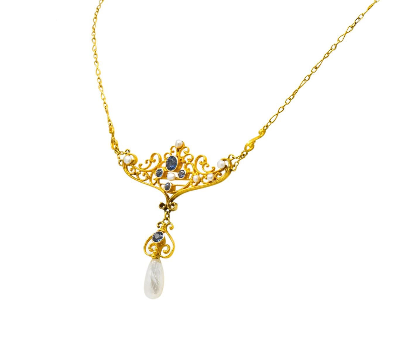 Designed as a matte gold scrolled motif necklace station with articulated drop and millegrain detail

Bezel set with five round cut sapphires weighing approximately 0.57 carat total, transparent and a grayish cornflower blue

Accented throughout